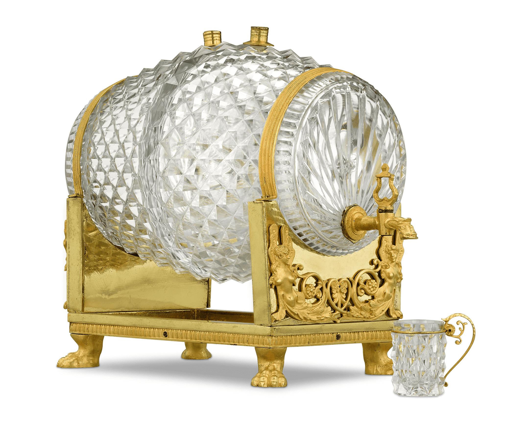 The legendary firm of Baccarat created this stunning Charles X-period cavé liqueur made to resemble a wine barrel. The crystal barrel resides in its doré bronze stand and is fitted with doré bronze spigot and stoppers. The vessel is joined by 11 cut