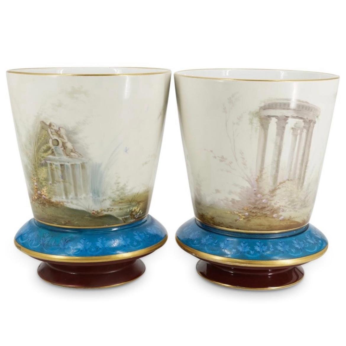 Our exceptionally rare pair of opaline jardinieres attributed to Baccarat are distinguished by their extensive enameling and finely painted neoclassical designs including maidens with cupid, putti at a fountain and Roman ruins, plus finely painted