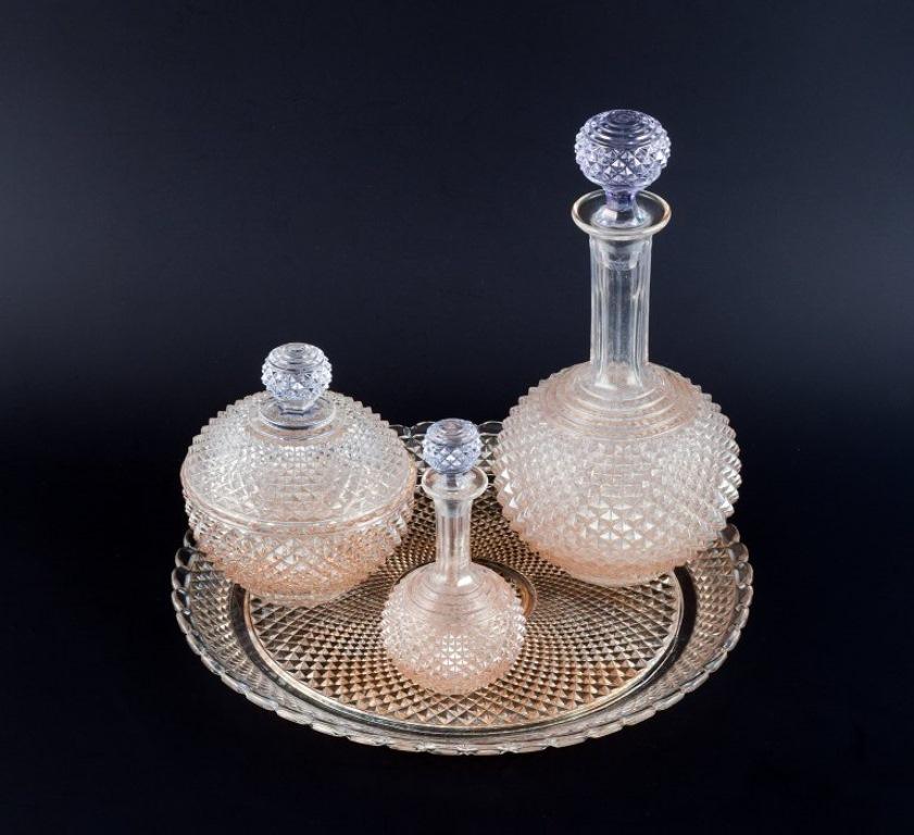 Baccarat, France, Art Deco crystal glass service with a wine carafe, covered bowl, and flacon on a round serving tray.
1930/40s.
Perfect condition.
Marked Baccarat, with an engraved model number on the bottom.
Tray: D 28.4 cm x H 2.0 cm.
Carafe: H