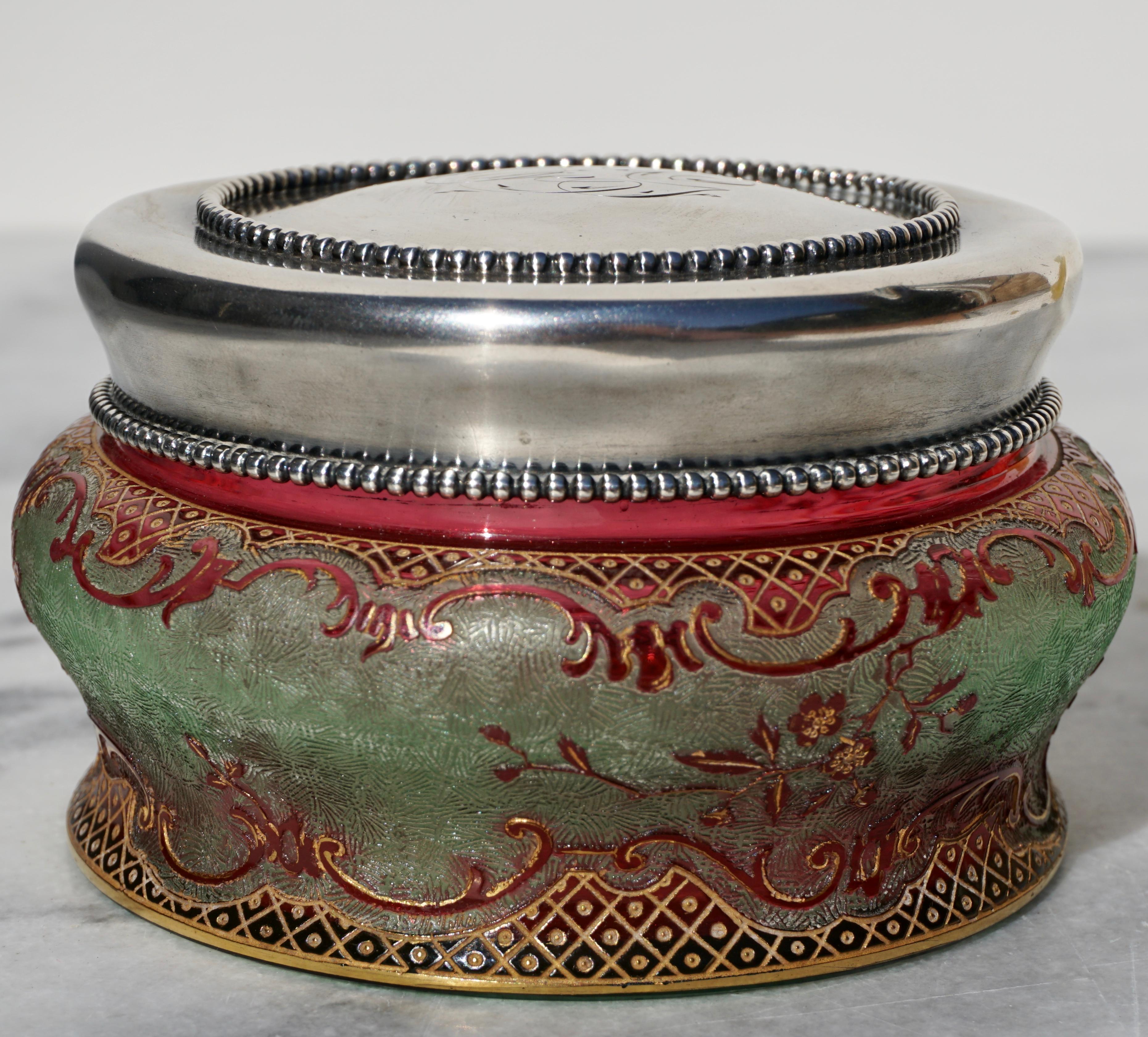 Baccarat Cameo Art Nouveau silver lidded crystal powder box. With a sterling silver monogrammed lid. This green and red overlay glass was carved, acid etched, enameled and gold gilt. Polished Pontic with Baccarat France depose acid etched on bottom.