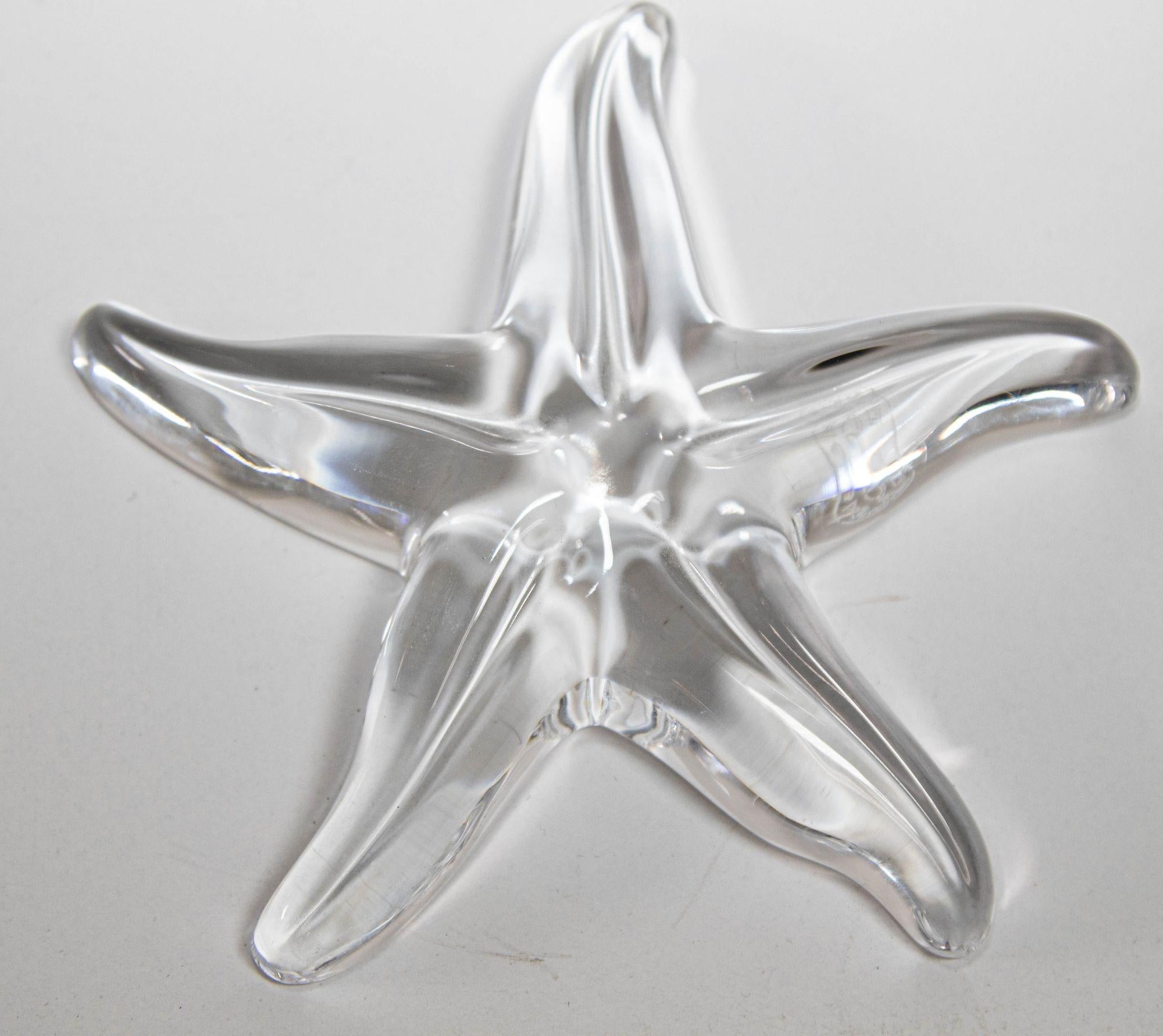 Vintage Translucent Crystal Starfish Paperweight by Baccarat France.
This elegant clear crystal art glass paperweight was realized by Maison Baccarat one of the world's finest makers of crystal products since 1765- in France.
It features five reeded