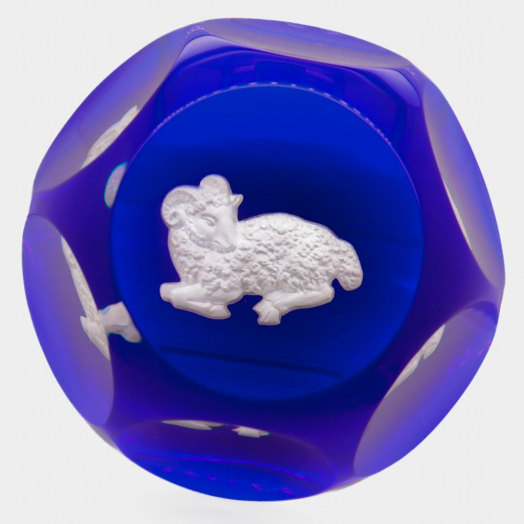 A fine, faceted French art glass paperweight.

From the Zodiac series. 

By Baccarat.

With a white sulphide depicting Aries, Chrysomallus the ram (from whom the Golden Fleece was shorn) on a blue ground. 

Marked with an acid-etched Baccarat