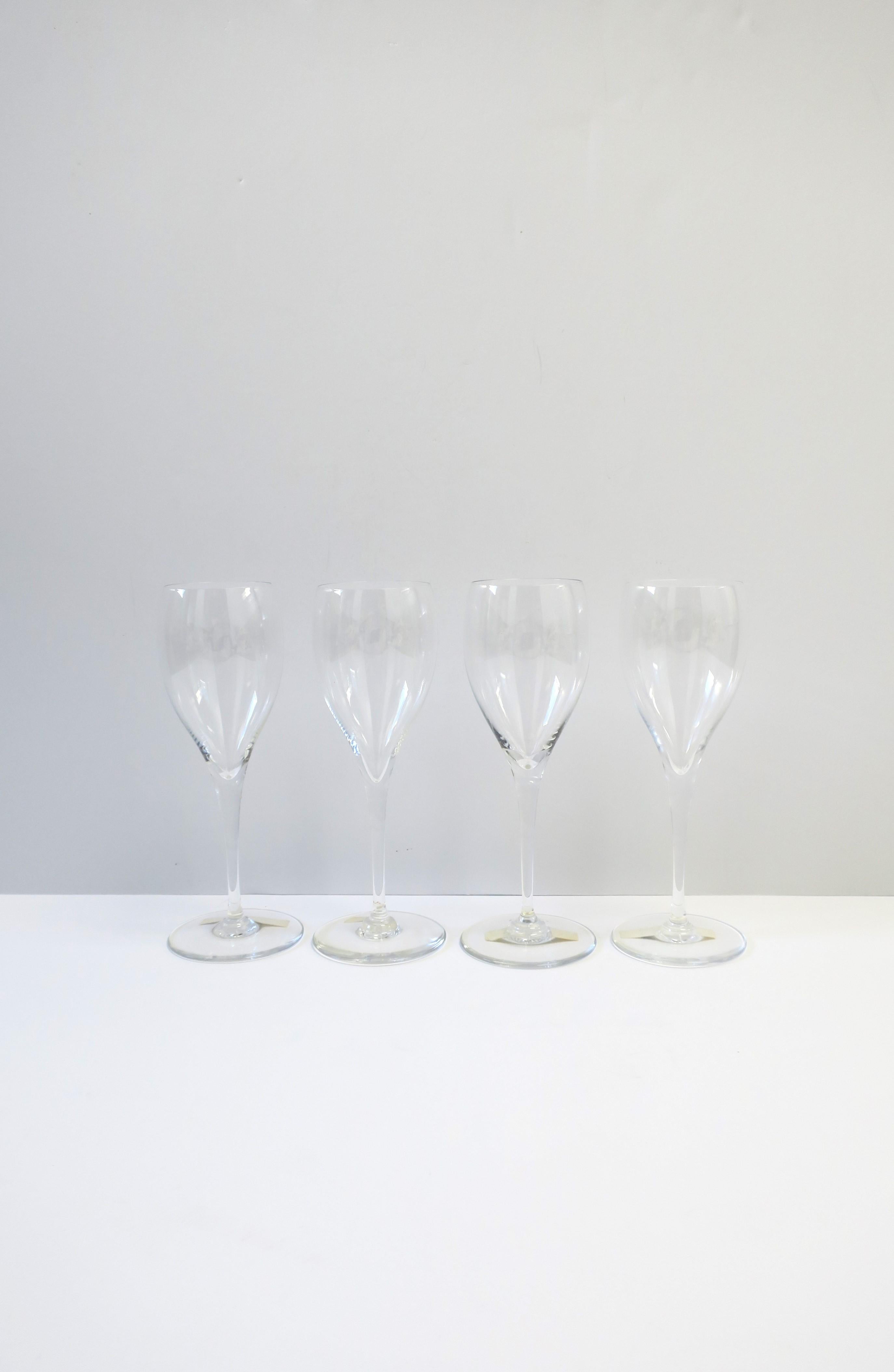 A beautiful set of four (4) French crystal cocktail or Champagne flutes / glasses in the St Remy design from luxury Maison, Baccarat, circa late-20th century, France. With makers' acid mark on bottom of all four: 