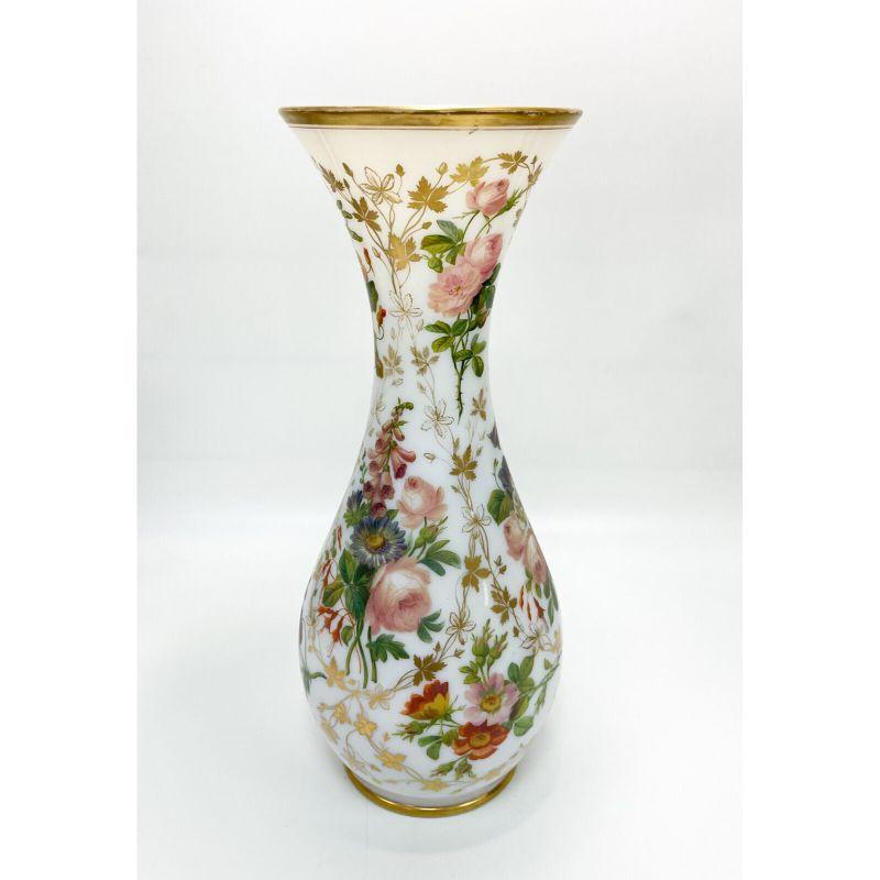 Baccarat French white opaline glass hand painted floral vase, circa 1900

French white Opaline glass hand painted floral vase, circa 1900. Beautiful hand painted multi-colored flowers with gilt leaves and gilt trim to to the top and base rim.