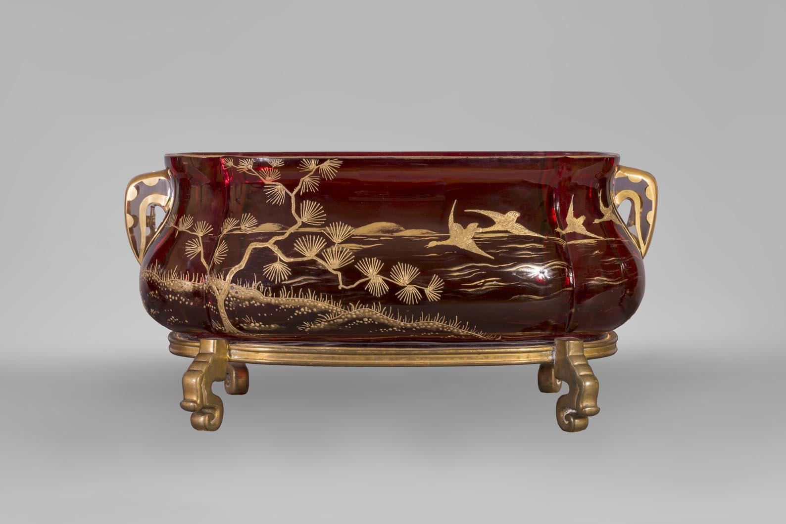 This decoration with a Japanese landscape was made by the Baccarat crystal factory around 1880. 

Founded under Louis XV, the French crystal factory Baccarat demonstrated its excellence at Universal Exhibitions throughout the 19th century.

This