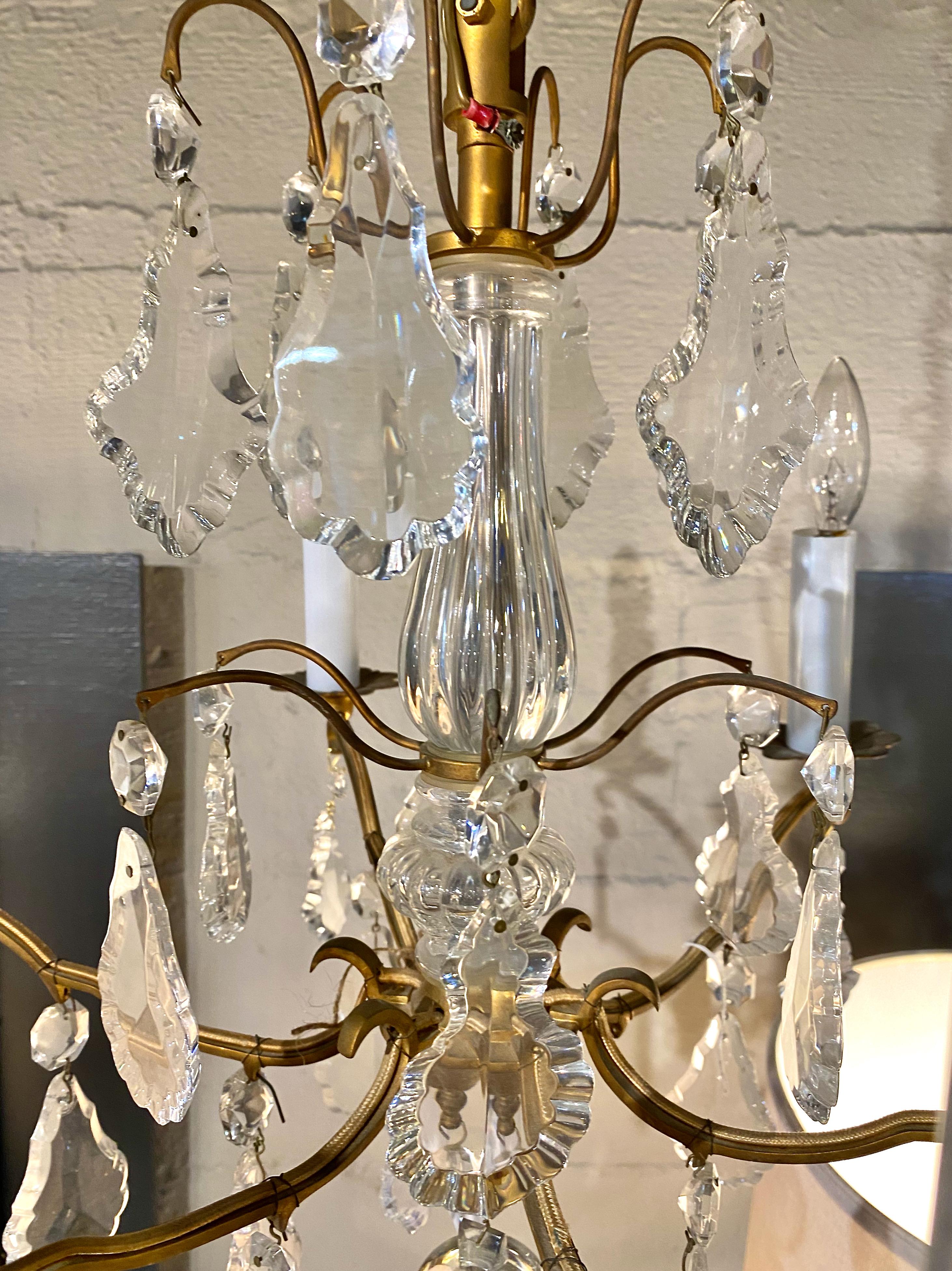 This a great example of a small Baccarat gilt bronze and cut crystal chandelier. The chandelier dates to the late 20th century. The quality of the bronze frame and lead crystal pendants speak for themselves. Please request images of the original