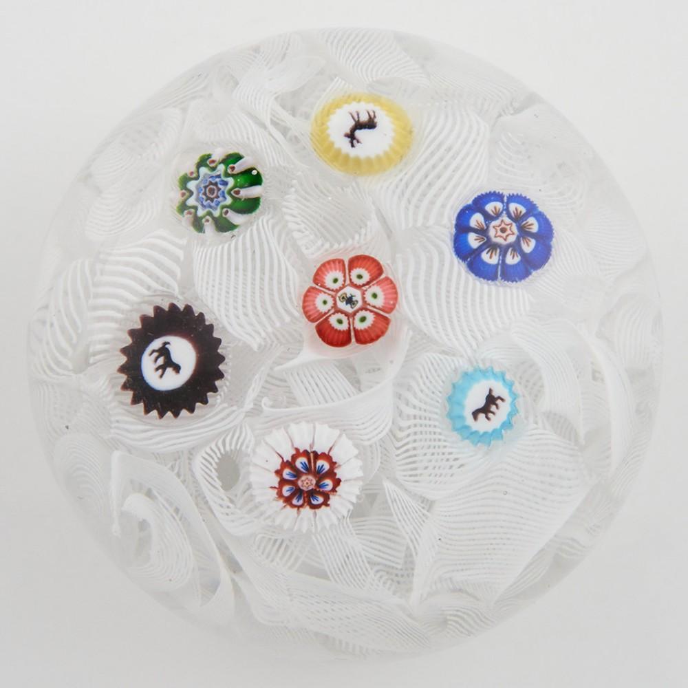 Heading : A Baccarat Gridels On Muslin Ground Miniature Paperweight c1850
Date : c1850
Origin : France
Features : Seven spaced millefiori canes, four gridel canes, dog, horse, deer, butterfly
Marks : None
Type : Lead
Size : 5.2cm diameter done