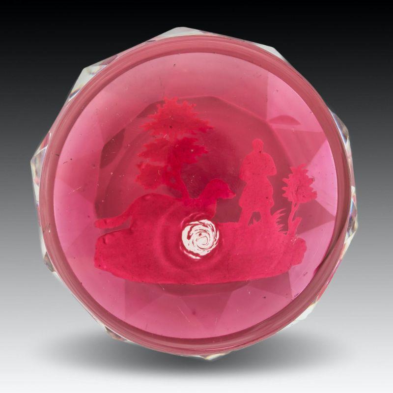 A Baccarat huntsman sulphide paperweight on translucent red ground
Measures: height 4.5 cm (1 3/4