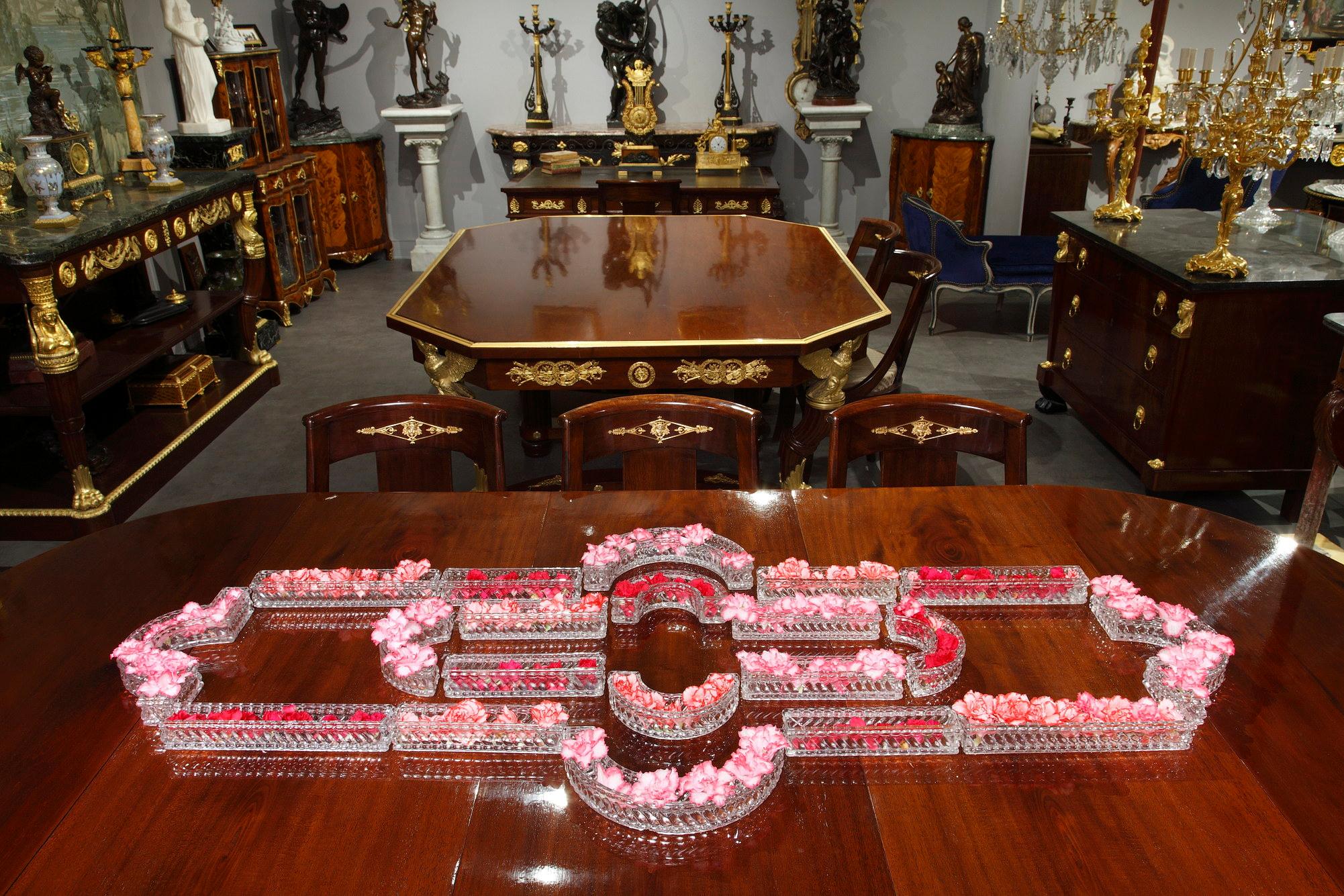 Baccarat table decoration in molded crystal composed of 10 rectangular elements, 4 half-moon elements and two pieces in the form of bridges. All the elements are signed Baccarat on the bottom. They can be arranged in a multitude of ways according to