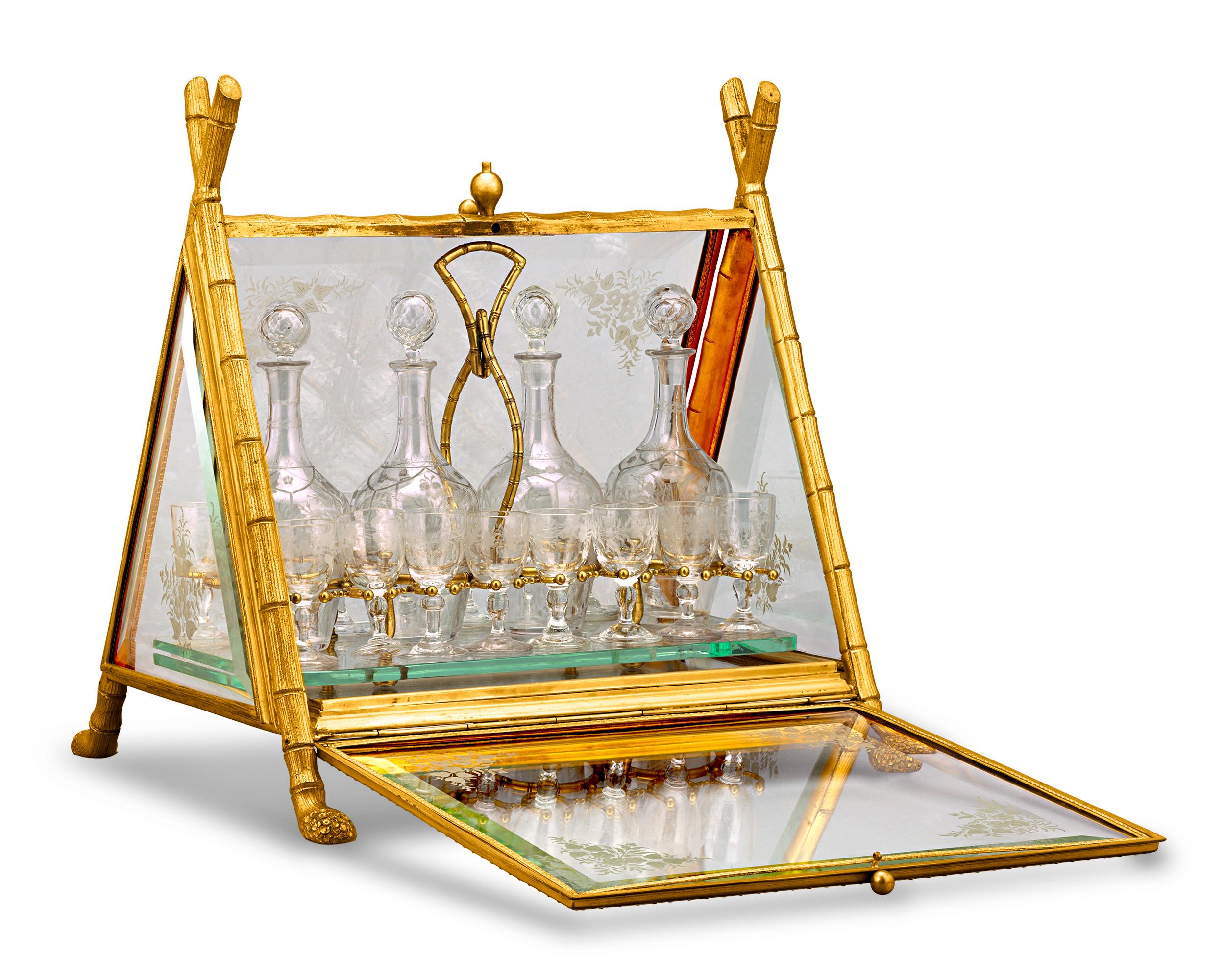 This charming and rare 19th-century cave à liqueur by the renowned cristallerie Baccarat gets a unique twist thanks to its oriental design. Taking the form of a palanquin, the doré bronze frame is fashioned in the style of bamboo shoots with root