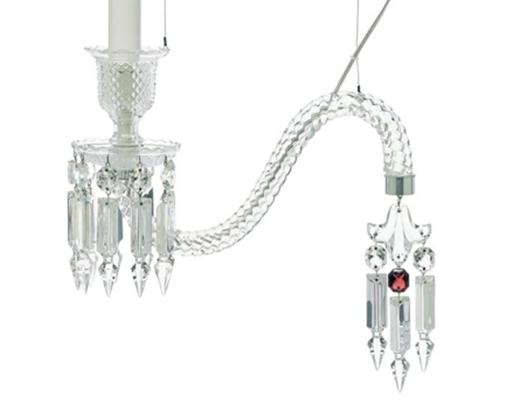 The unit draws inspiration from the form of Baccarat's illustrious Zénith chandelier by reinventing and deconstructing its exquisite elements in an unexpected way. The unit drips with clear cut-crystal pendants. The  Baccarat's signature is the 