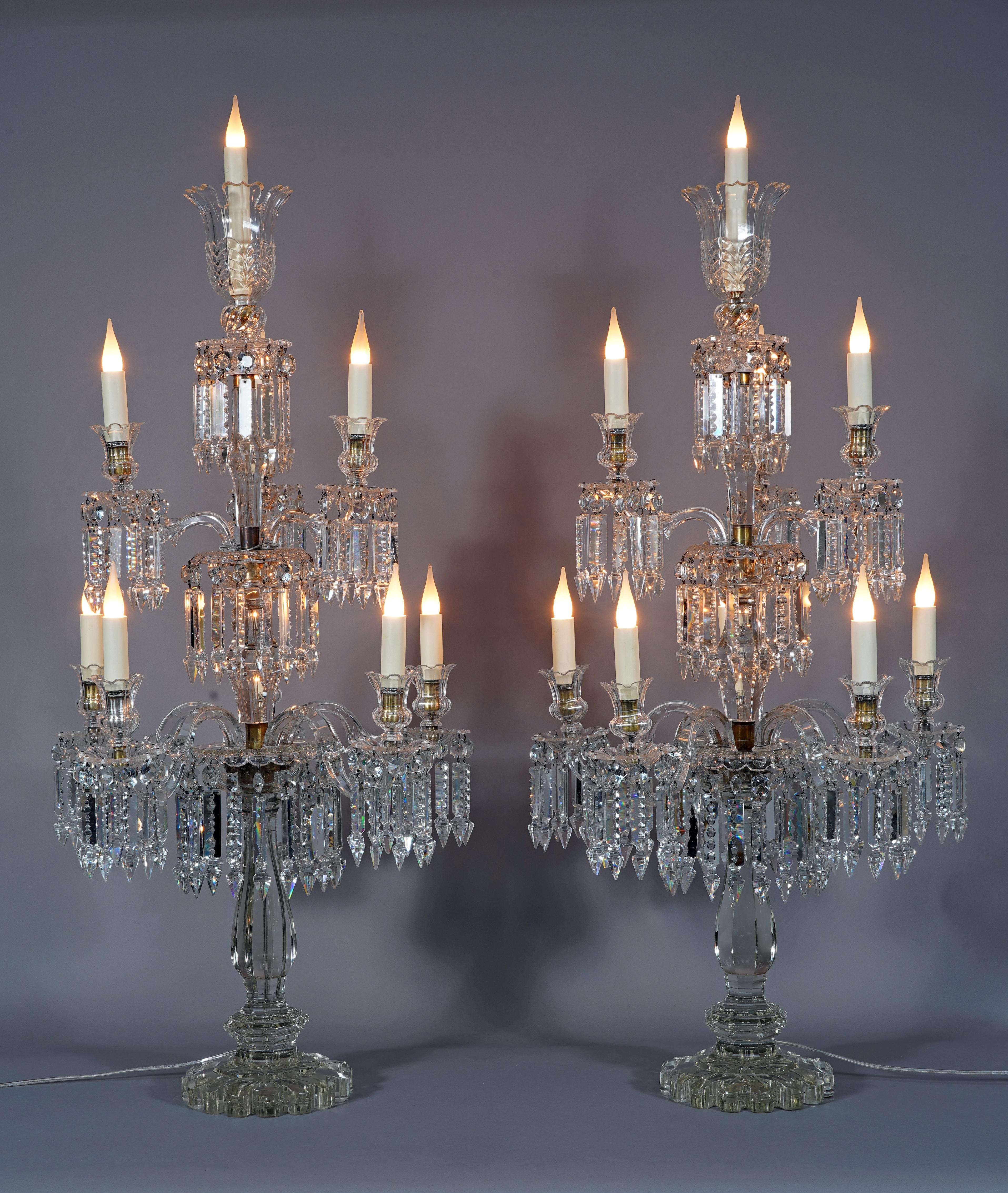 Beautiful pair of Baccarat cut crystal candelabras with ten lights. The central baluster-shaped shaft illuminates with two superimposed rows of six and three light arms with twisted branches, and is topped with a corolla. The whole is decorated with