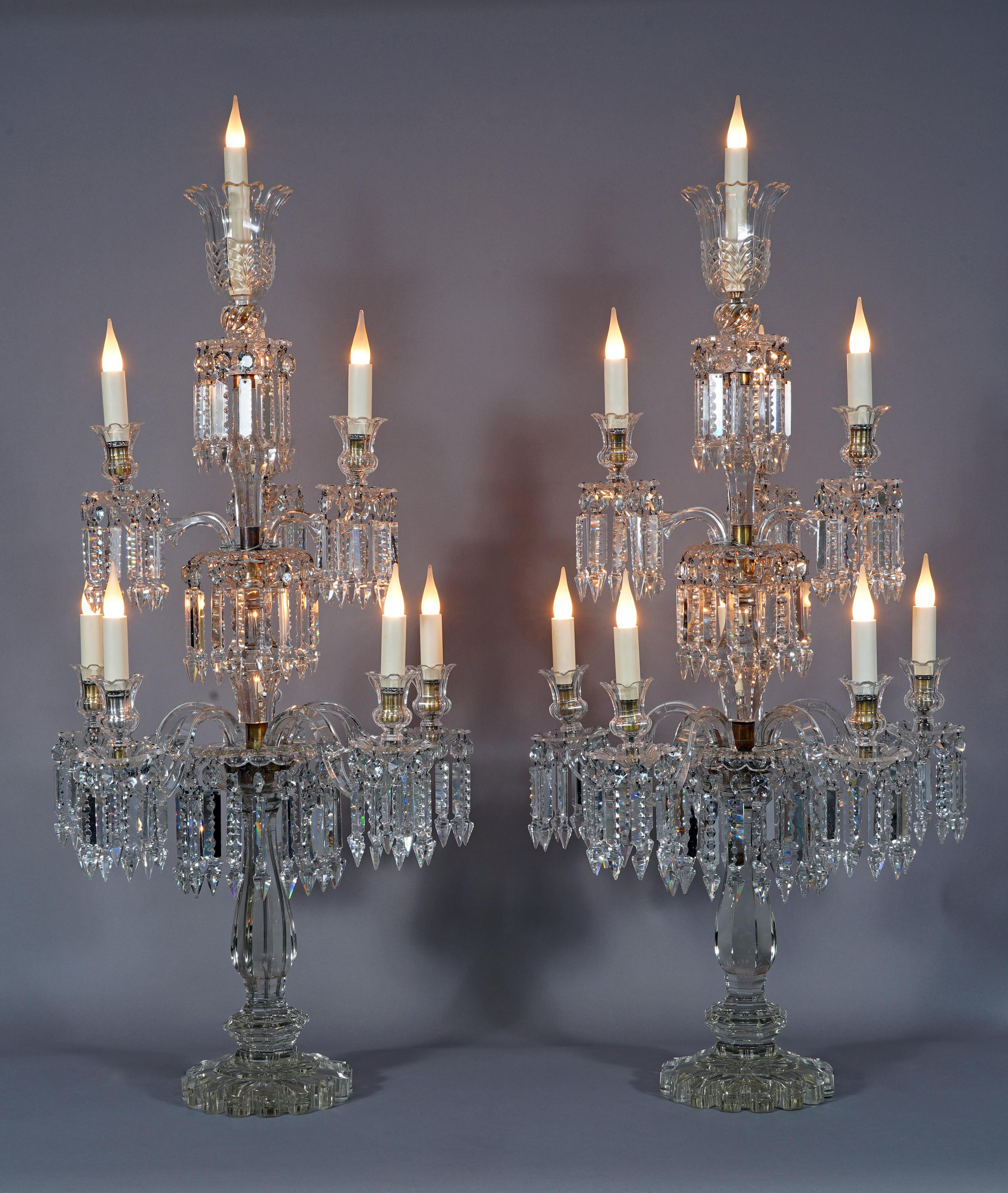 Beautiful pair of Baccarat cut crystal candelabras with ten lights. The central baluster-shaped shaft illuminates with two superimposed rows of six and three light arms with twisted branches, and is topped with a corolla. The whole is decorated with