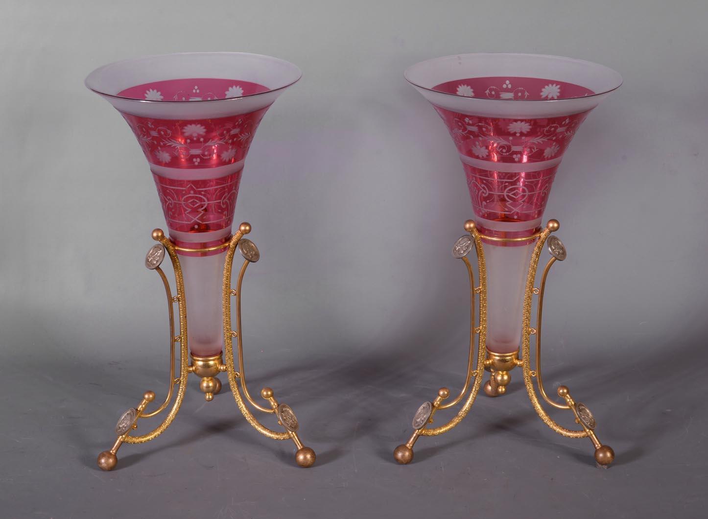 Founded under Louis XV, the French crystal factory Baccarat demonstrated its excellence at Universal Exhibitions throughout the 19th century. 

This pair of vases, with an elegant flare, is characterized by its alternating colors. This is obtained