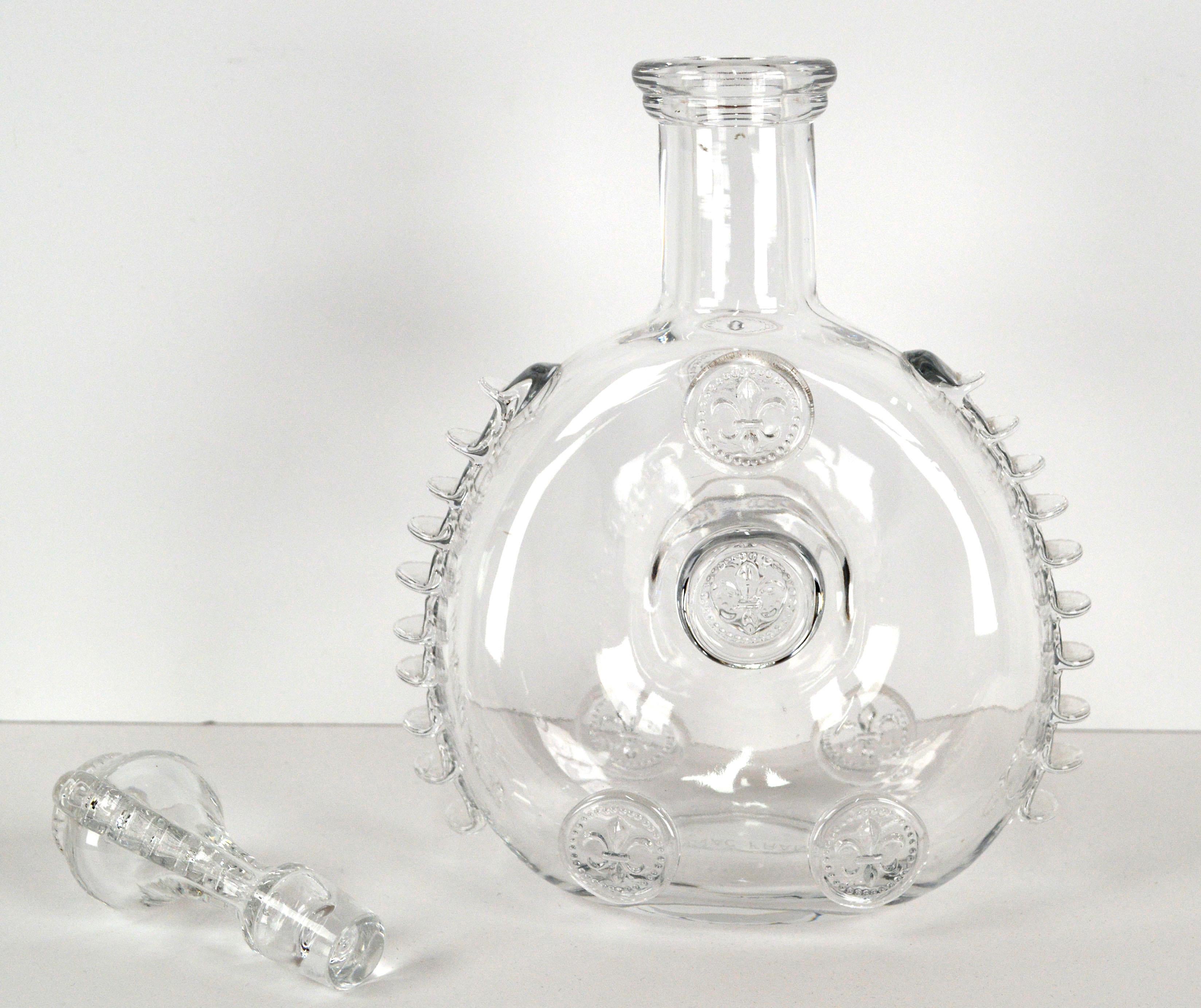 Elegant Remy Martin Baccarat crystal cognac decanter bottle with matching stopper, by fine crystal manufacturer Baccarat (French, founded 1764). The ornate stopper and fine details of ribbed spines along each side make this unique decanter an
