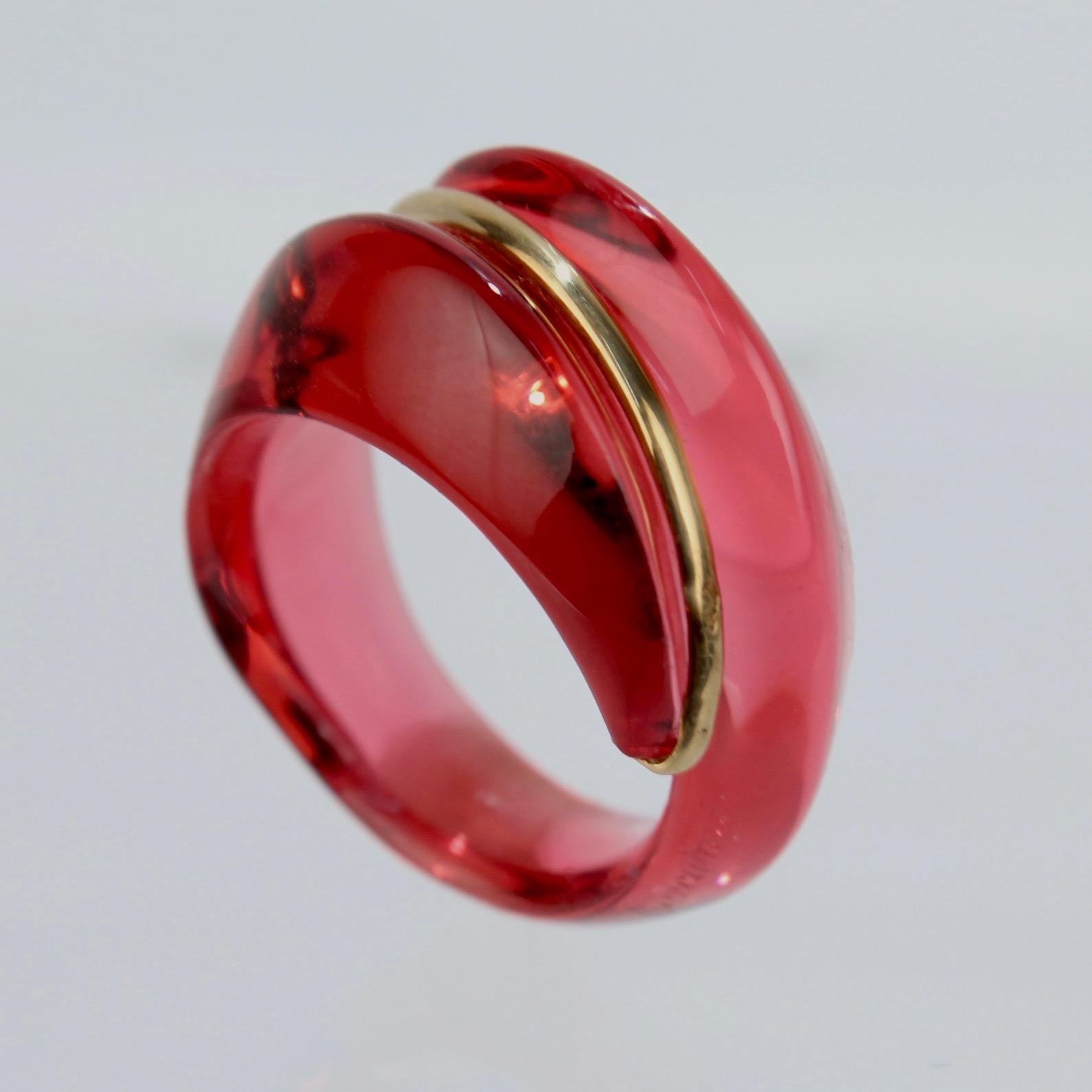 A wonderful Baccarat Coquillage ring.

In ruby red glass and 18k gold.

Great modernist jewelry design from France's premier glass house!

Marked with an acid-etched Baccarat factory mark, a French assay mark, and 750 for 18k gold fineness.

Ring
