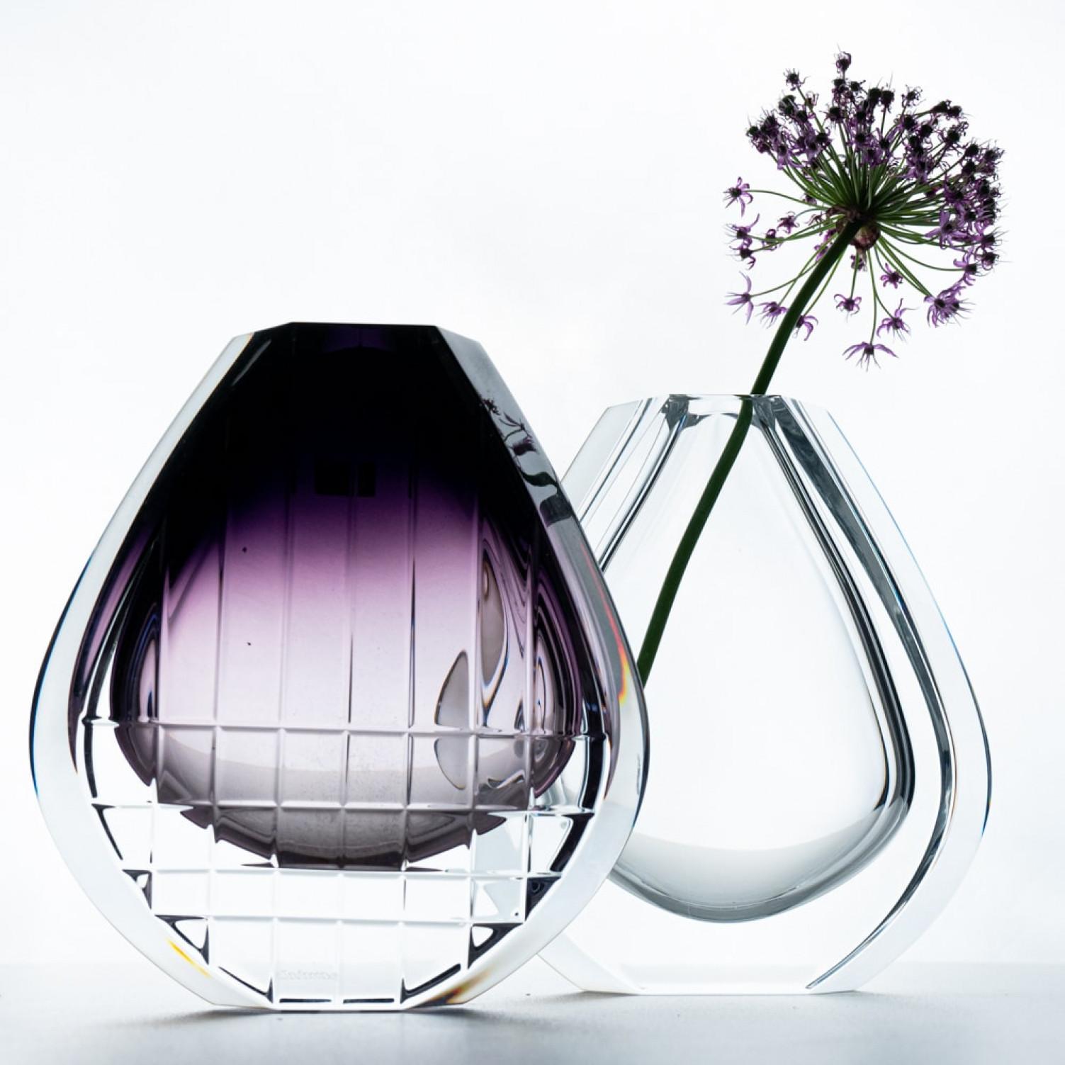 Luxury at its finest, high-end crystal vases made by Baccarat. This models are produced from 1987 to 1994. Both vases having flat tear dropped shaped body's. One vase is full body clear and the other vase has geometric cuts and a gradient amethyst