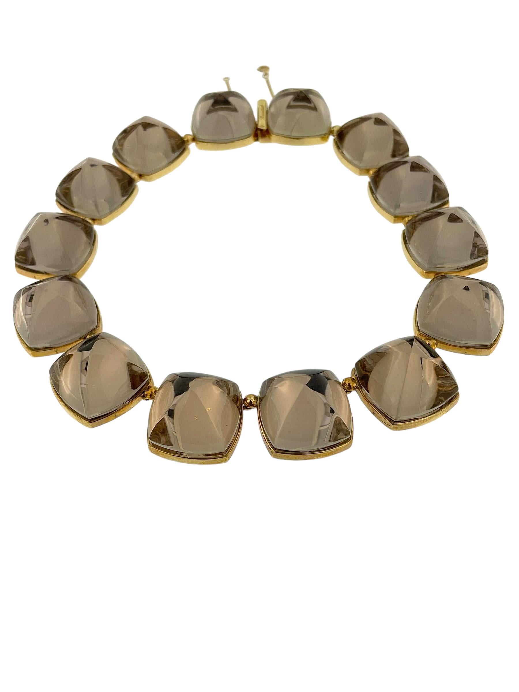 This Baccarat Smoky Crystals and Yellow Gold Necklace is a captivating piece that elegantly combines the brilliance of 18-karat yellow gold with the rich, sophisticated tones of smoky crystals. The necklace showcases Baccarat’s renowned crystal
