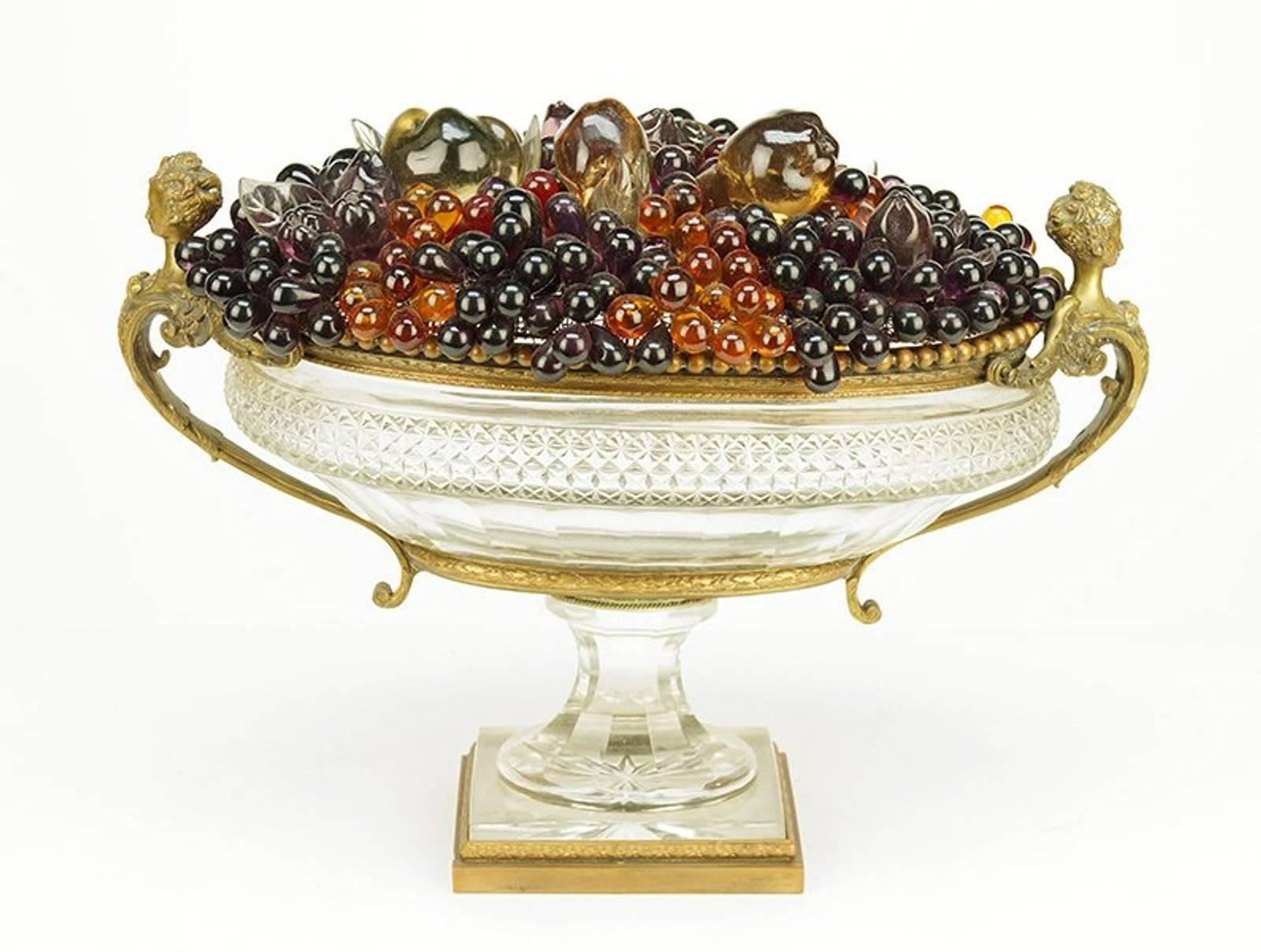 A French bronze and crystal centre bowl. Square bronze base supports a tapered crystal pedestal and oval bowl with winged maiden form handles. Underside is stamped 
