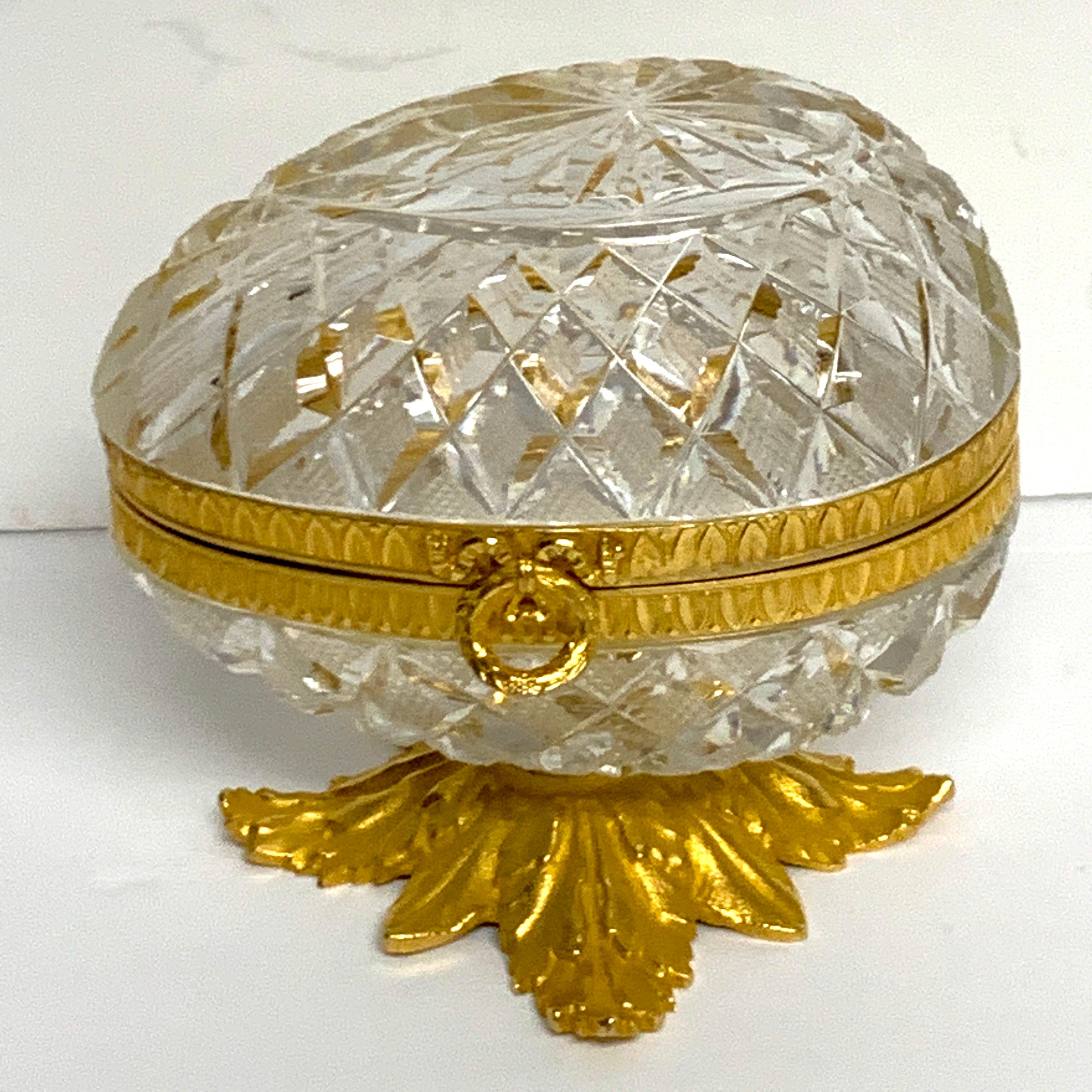 Baccarat style cut glass and ormolu egg motif box, unusual shape. No flaws observed ready to place. Raised on a 3.5