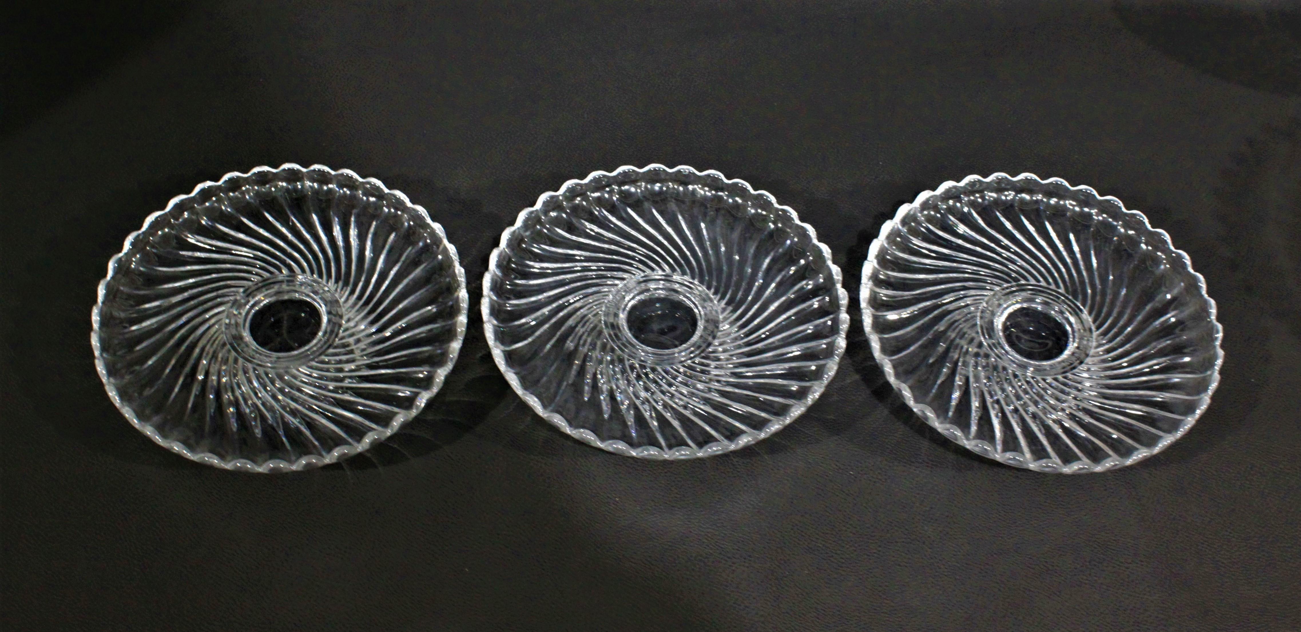 This set of five swirled crystal pedestal cake stands or servers date from the Late 19th Century and made by Baccarat of France. The swirled pattern displayed in surface areas of each piece is replicated in the bases. The set is composed of two