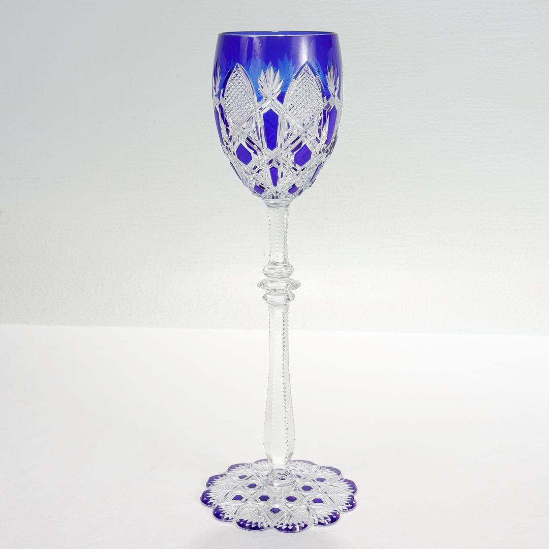 A wonderful & rare Baccarat wine goblet in the coveted Tsar pattern.

Initially introduced in 1906.

In colored cobalt blue overlay glass with a scalloped foot and palm & leaf decoration.

Marked to the base with a factory acid etched mark to