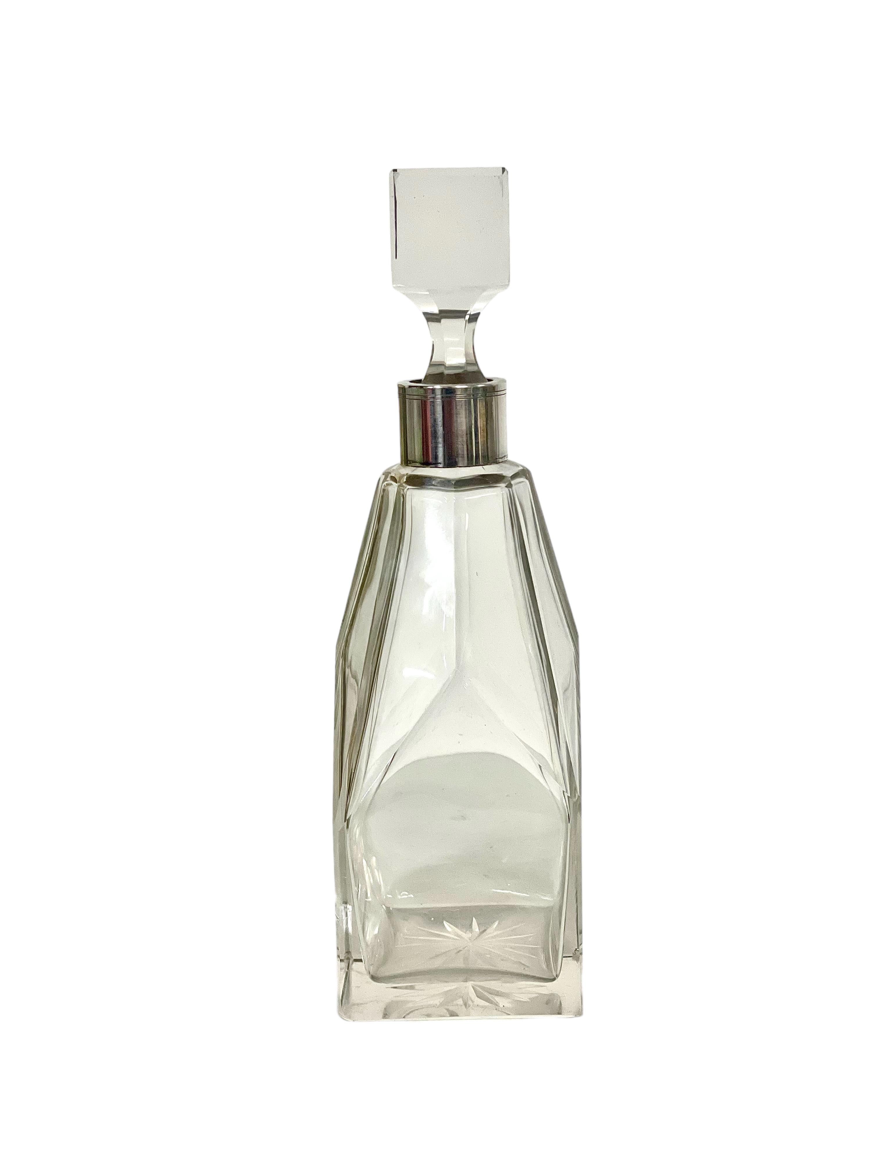 An impressive cut crystal lidded decanter with silver-plated collar made by renowned crystal manufacturer Baccarat. This stylish piece of barware has been meticulously crafted from fine crystal, and features four faceted sides that brilliantly