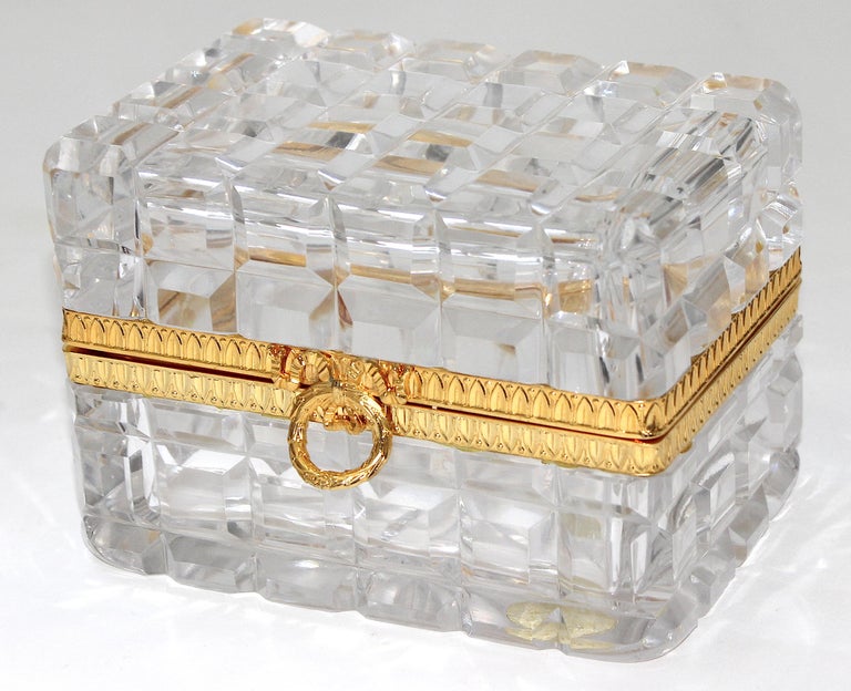 This stylish and chic Baccarat style hand-cut lead crystal and gold-plated box dates to the 1960s and will make a beautiful addition to your dressing table to hold many possibilities.

 Note: The lid opens at about a 45 degree angle. (See Image #7)