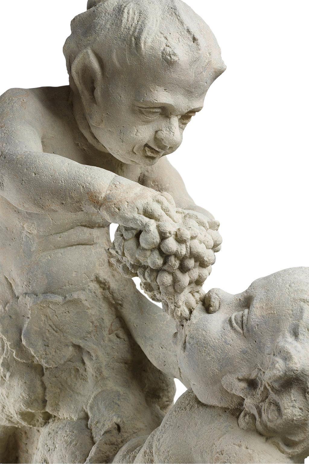 Franconia, around 1775
Sandstone. A putto sitting next to an overturned wine jug is being fed grapes by a small satyr. The almost life-size sculpture belonged - it can be assumed from the traces of weathering - to a lavishly decorated rococo garden