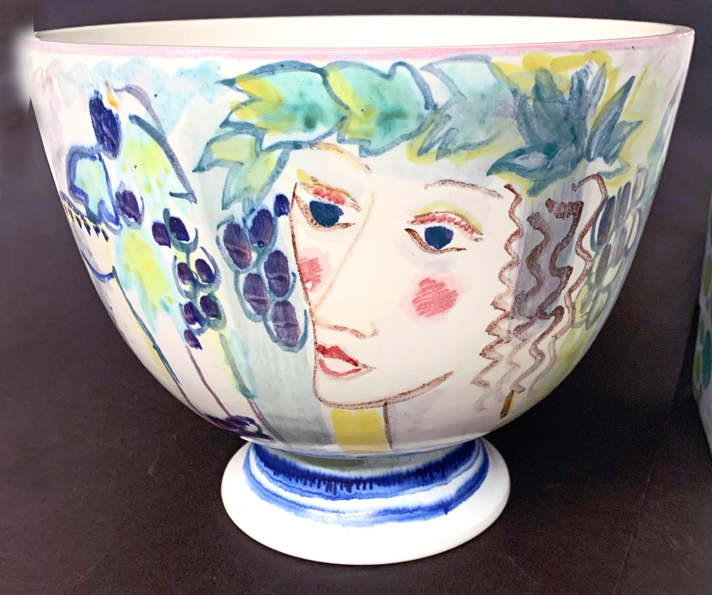 Brilliantly glazed in vivid shades of cerulean, lilac, rich yellow and purple, this punsch bowl decorated with Bacchus figures, grapes and pitchers of wine was designed and executed by Carl-Harry Stalhane, one of the wunderkinds of 1940s Swedish