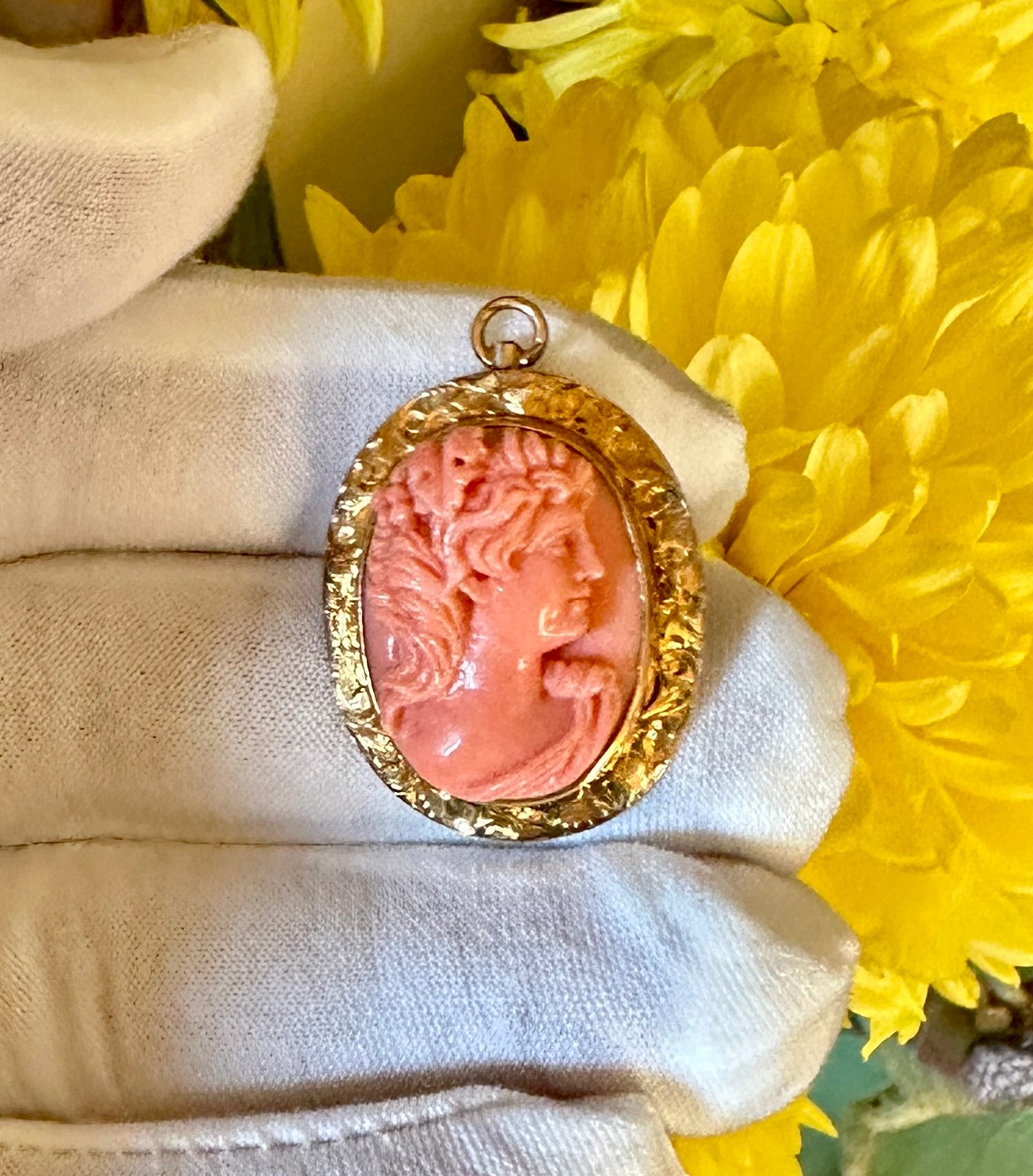 This is an absolutely stunning antique Coral Cameo Pendant depicting the God Bacchus dating to the Victorian to Edwardian period.  The Coral Cameo of Bacchus is a very deep exquisite hand carved cameo with masterful carving of the head of the God