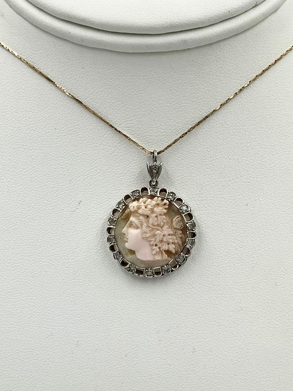 A stunning antique Victorian - Belle Epoque Pendant of a magnificent hand carved face of Bacchus, also known as Dionysus.  The stunning carved face is set in a platinum open work surround with 14 gorgeous antique Diamonds with a Diamond set bale. 