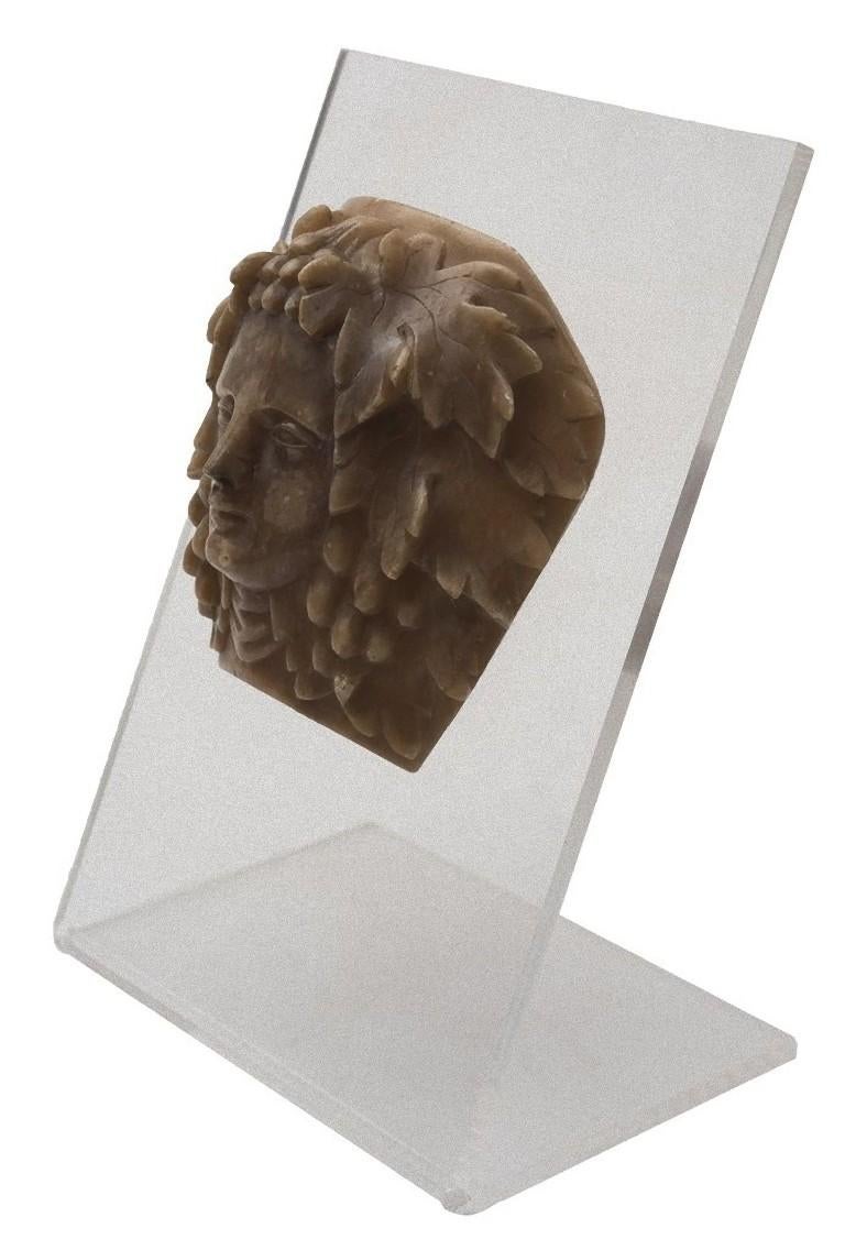 This Bacchus head is an original decorative wax object realized in Italy by Italian manufacture during the first half of the 20th century.

This high relief sculpture realized in wax represents the face of divinity (probably Dionysus) framed by