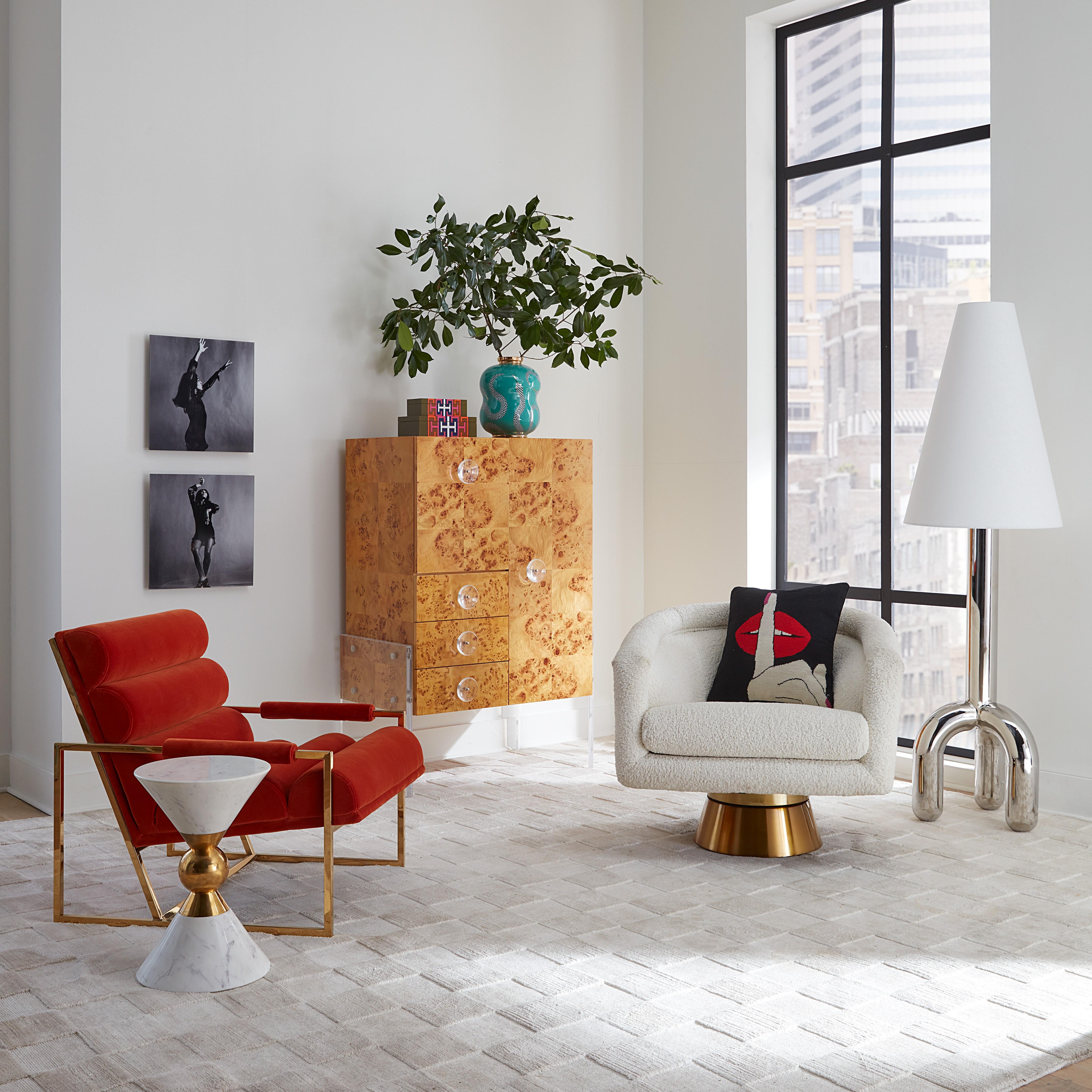 Louche glamour. Think Halston, think Studio 54, think sybaritic style. But also think cozy, comfy swivel chair. Upholstered in ivory teddy with an architectural antiqued brass swivel base.

Specs & Care:
Seat depth: 20.5 in
Loose seat