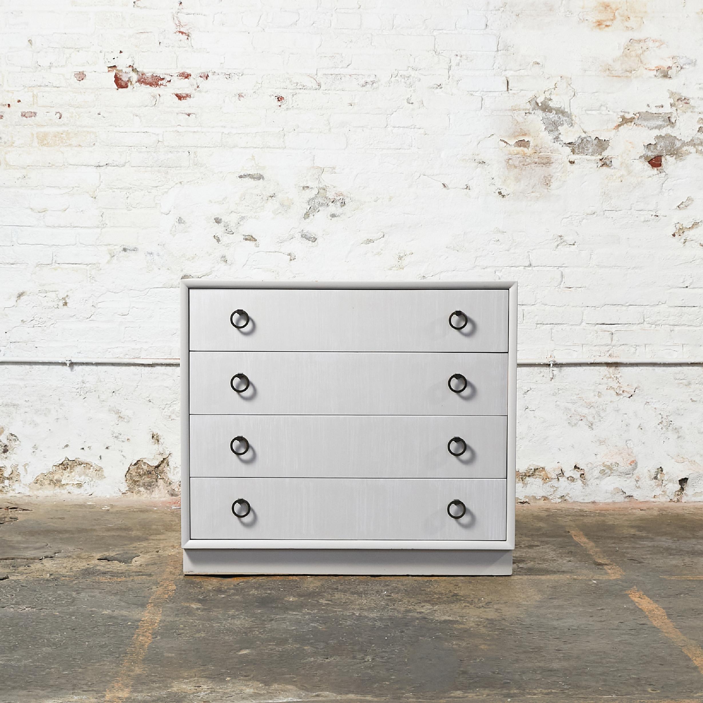 Bacherlo Chest by T.H. Robsjohn-Gibbings for Widdicomb. This piece has been re-finished in a neutral light warm grey patina with white brush strokes. Clean design pull rings finished in antique bronze.