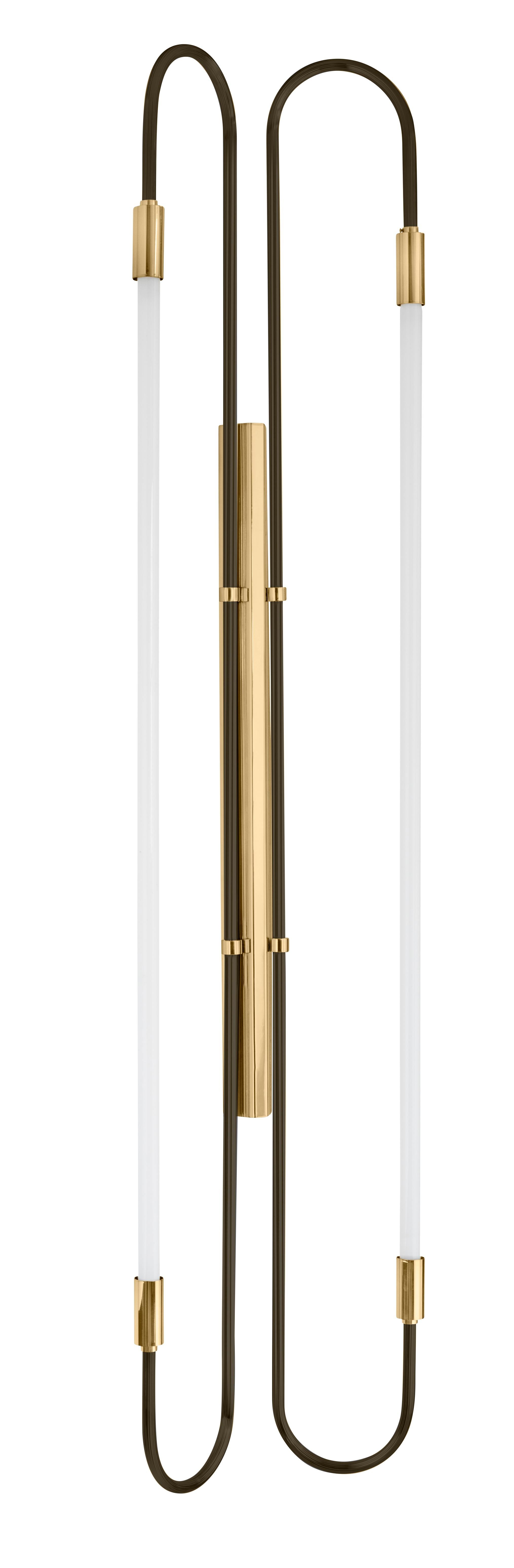 Back and brass wall lamp Neon Double 170 by Magic Circus Editions
Dimensions: H. 170 cm, W. 37 cm, D. 11 cm, 3.6 kg.
Materials: fluted brass tube and glass.
Available finishes: brass (lacquered polished brass, unlacquered polished brass, brushed
