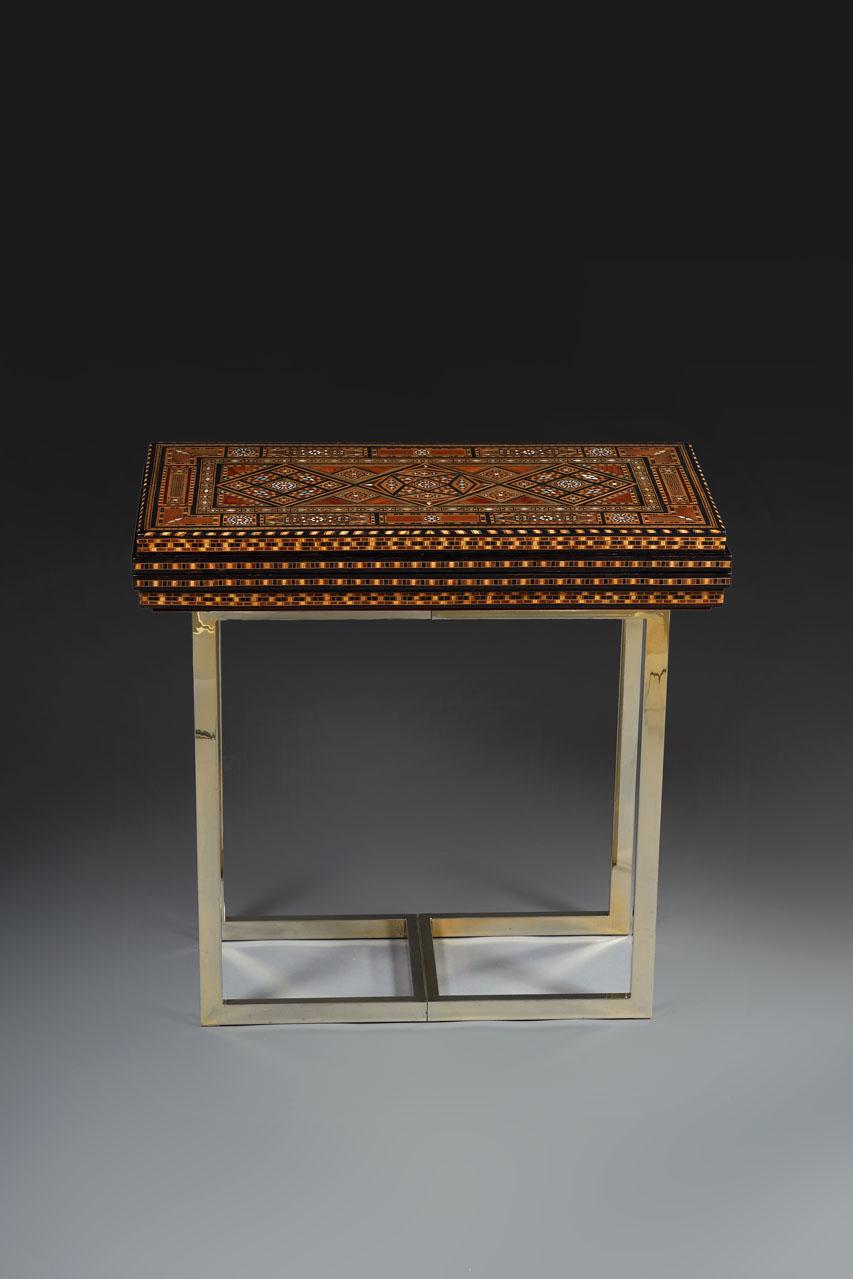 Modular Syrian game table veneered in precious woods, adorned with marquetry and inlays of mother-of-pearl and ivory on each side. Open, this Syrian game table features a trictrac or backgammon board and a chessboard. The closed game board is