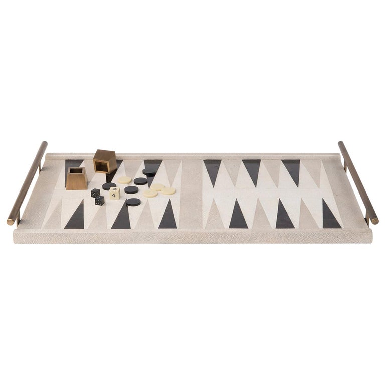The Kifu Paris Backgammon game tray is the ultimate luxury game. Accented with a mixture of shagreen, pen shell and bronze-patina brass this piece comes with all game parts in a velvet pouch. Available in a light or dark color-way. 

The dimensions
