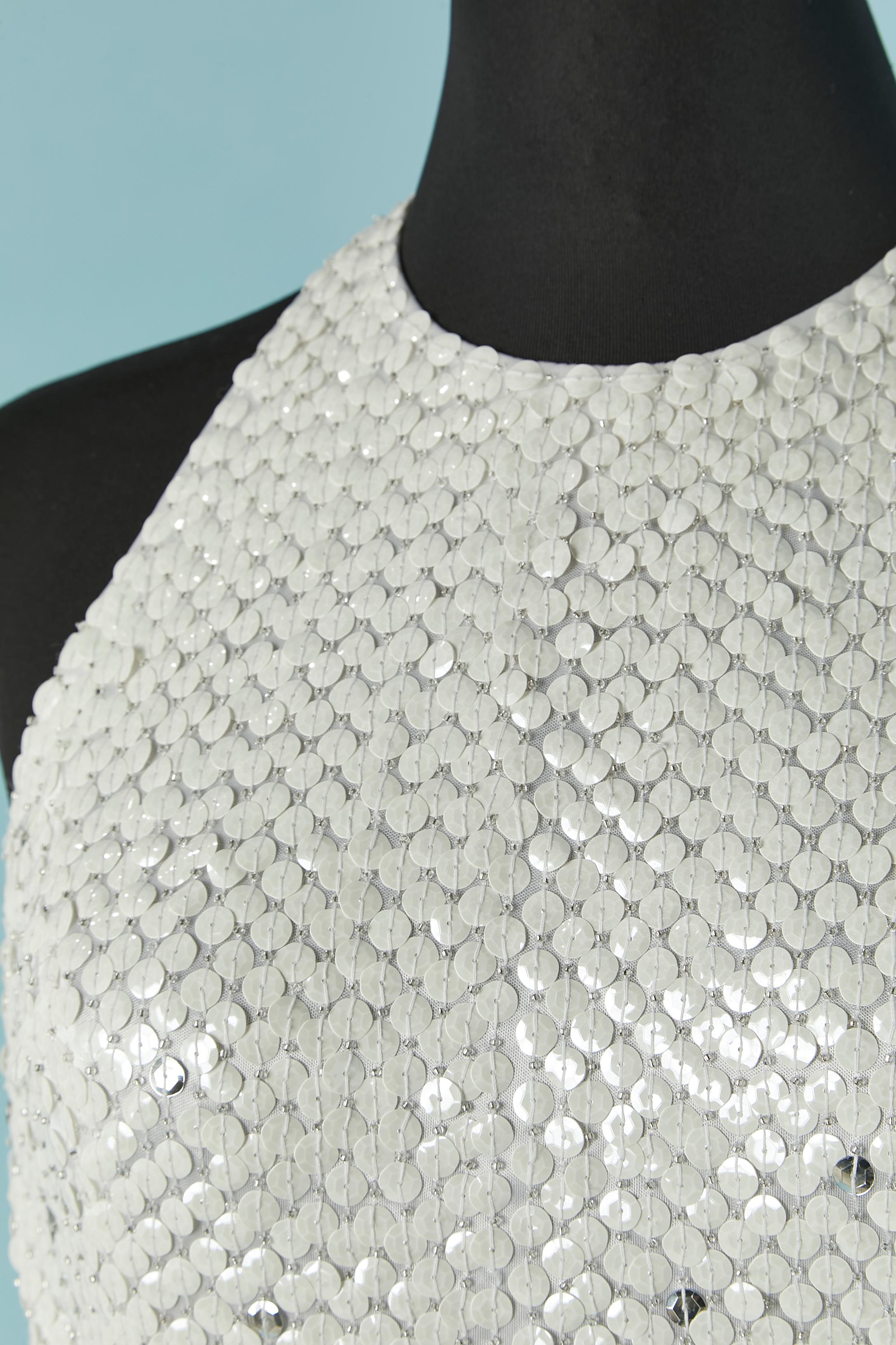 Backless evening dress in silver and white sequin . Fabric composition: 100% polyester. Zip and hook&eye closure on the middle back + hook&eye closure on the top middle back. Split middle back, lenght= 60cm
SIZE 4 (US) S/M