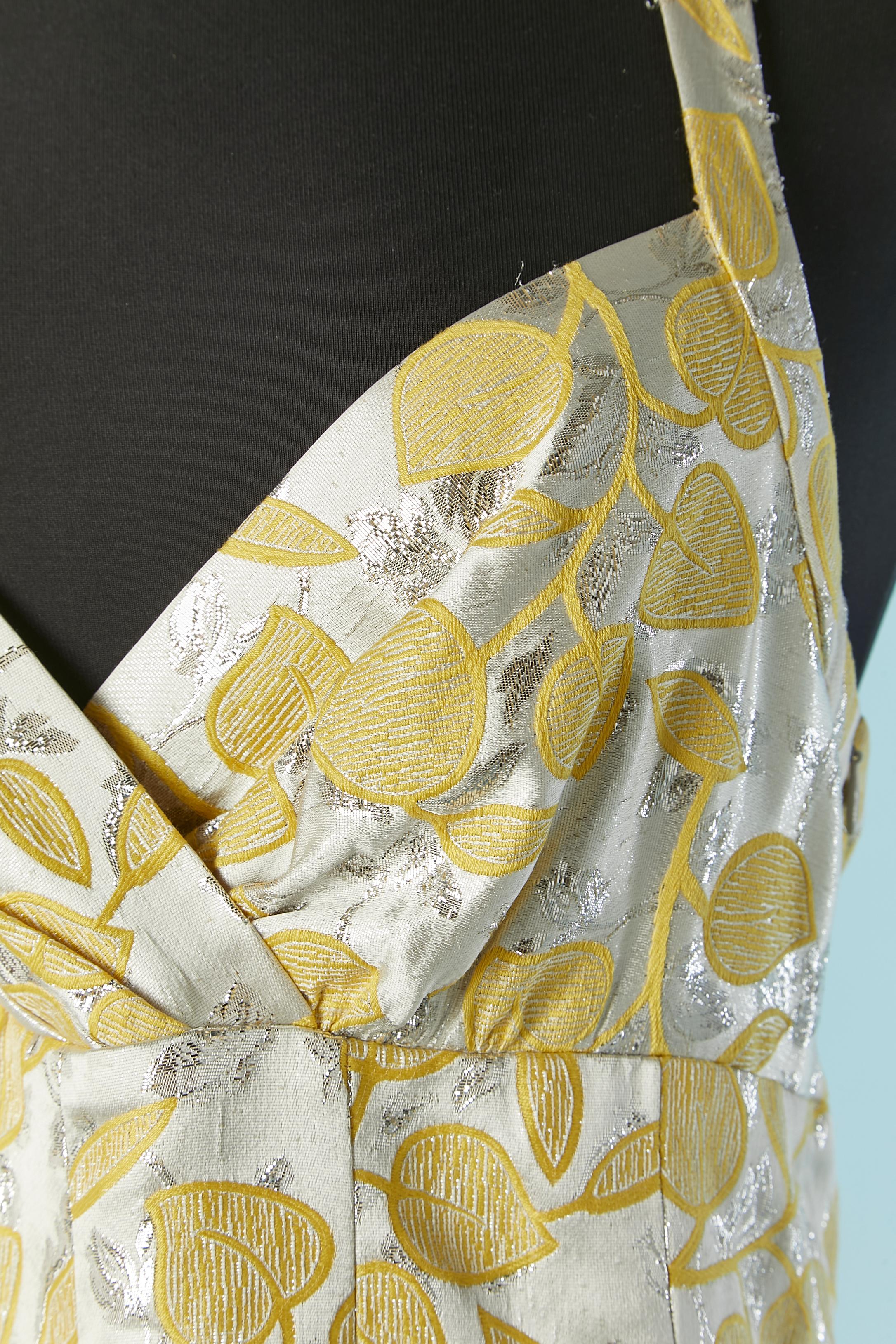 Backless silver and yellow cocktail dress. Main fabric composition: 56% cotton, 36% acetate, 8% metal. Lining composition: 60% acetate, 40% rayon. 
Zip closure on the left side. Button and buttonhole closure on the back of the neck. Pocket on both