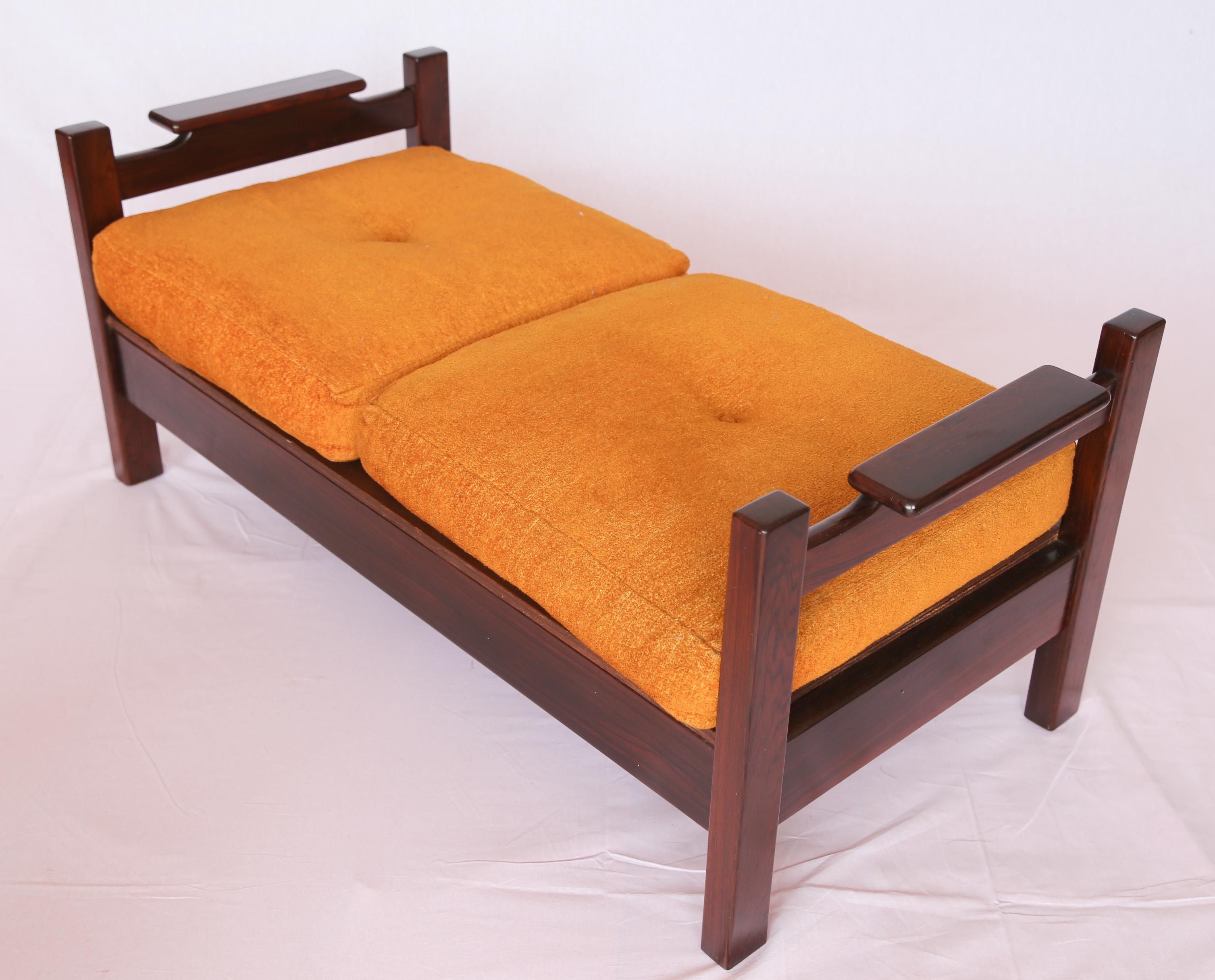 Available immediately, this Brazilian Modern Bench in Hardwood & Orange Cushions by Fatima Moveis is stunning!

This midcentury modern bench is made of Brazilian Rosewood, as known as Jacaranda, and has delicate woodwork to the sides. The seat has
