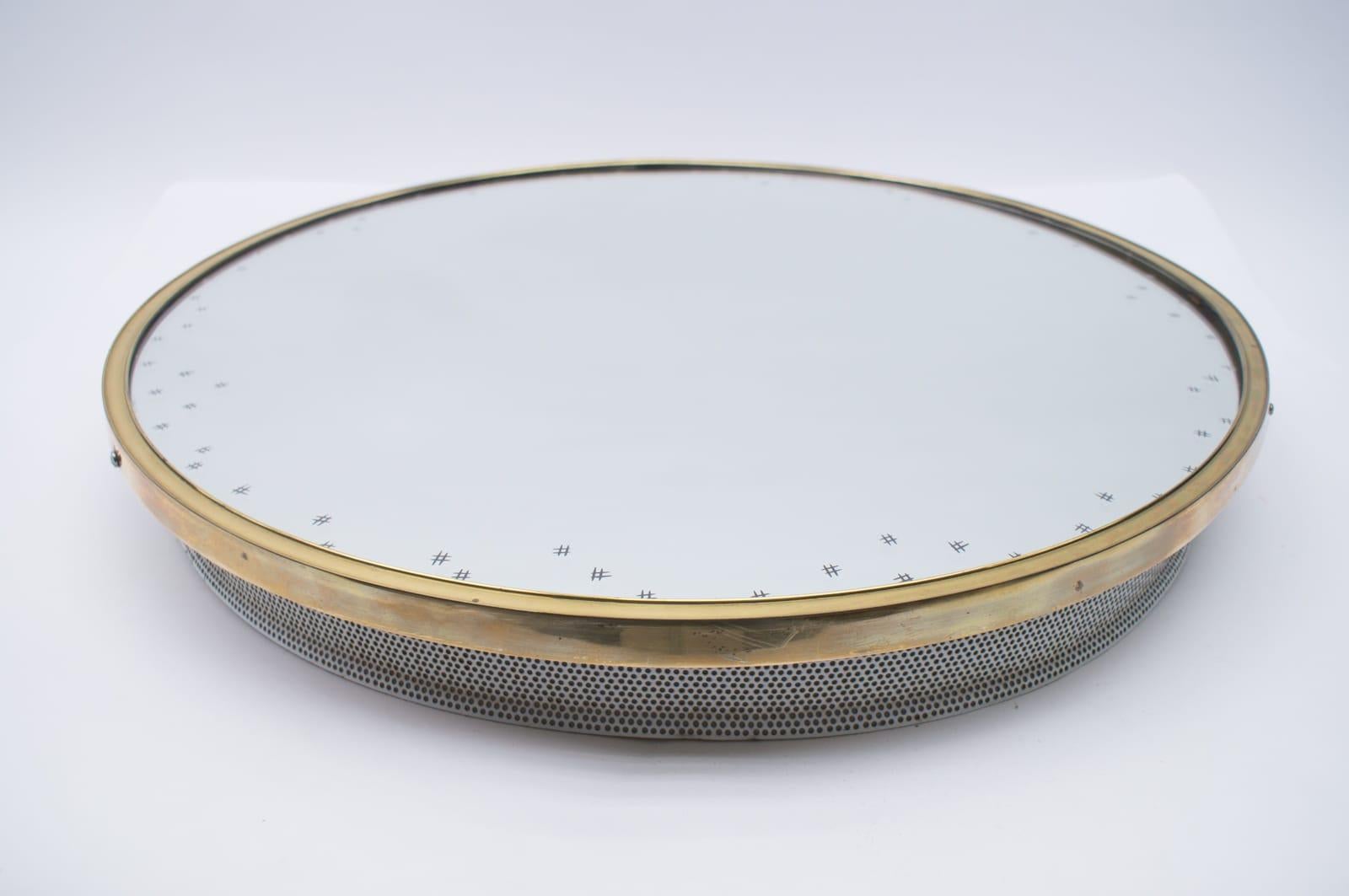 A round wall mirror with a circular tube light behind it.

 