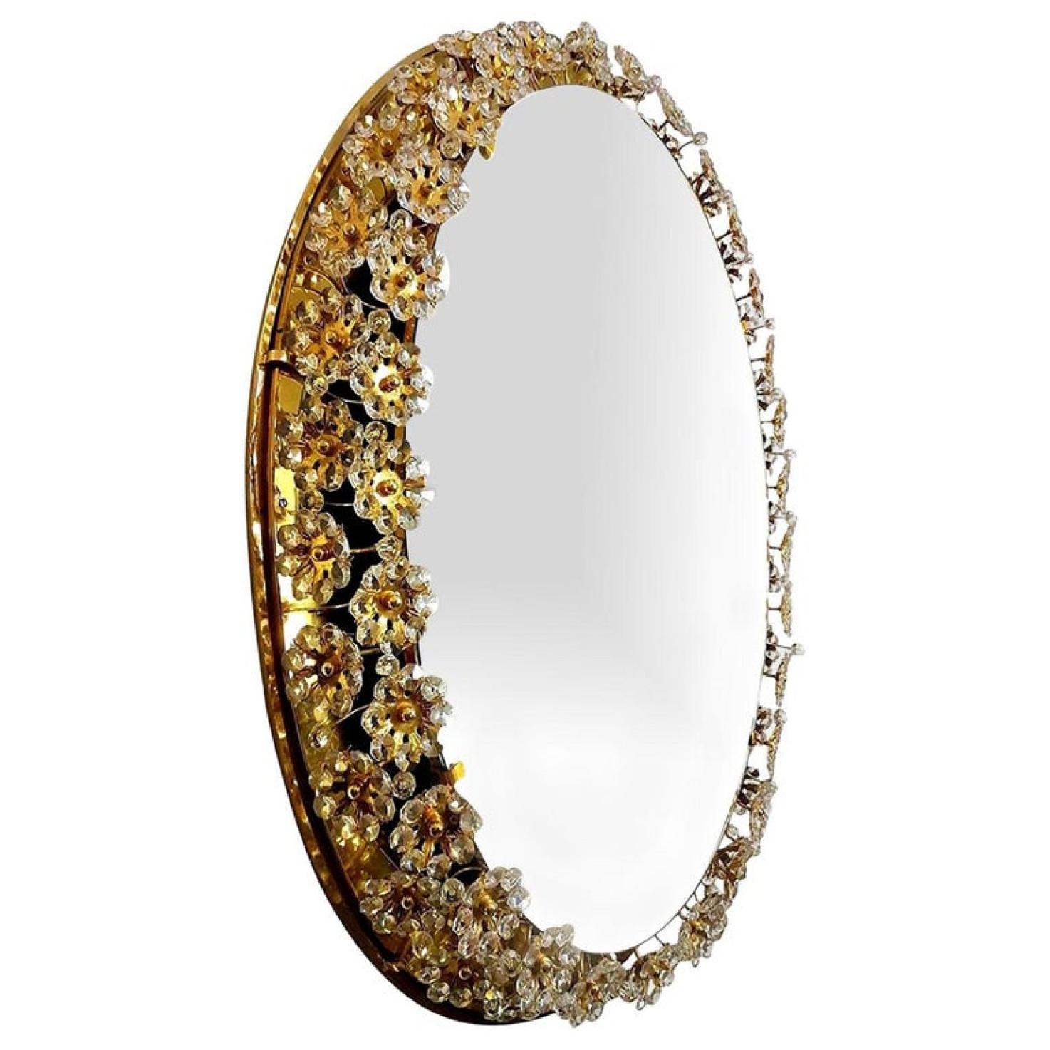 A gorgeous gilded oval floral illuminated wall mirror, manufactured in the 1970s by Palwa. Handcrafted frame, made of gold-plated brass, covered with jewel like faceted crystal glass petals.

Cleaned, well wired and ready to use. In very good