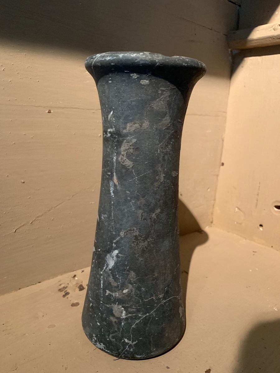 Bactrian marble column idol, circa 3000-2000 Bc. It has a elegant tapering form with a undeep groove running on the top and bottom. The marble is strikingly vained in a greyish black color. It has incrustation on the side where it laid on the sand