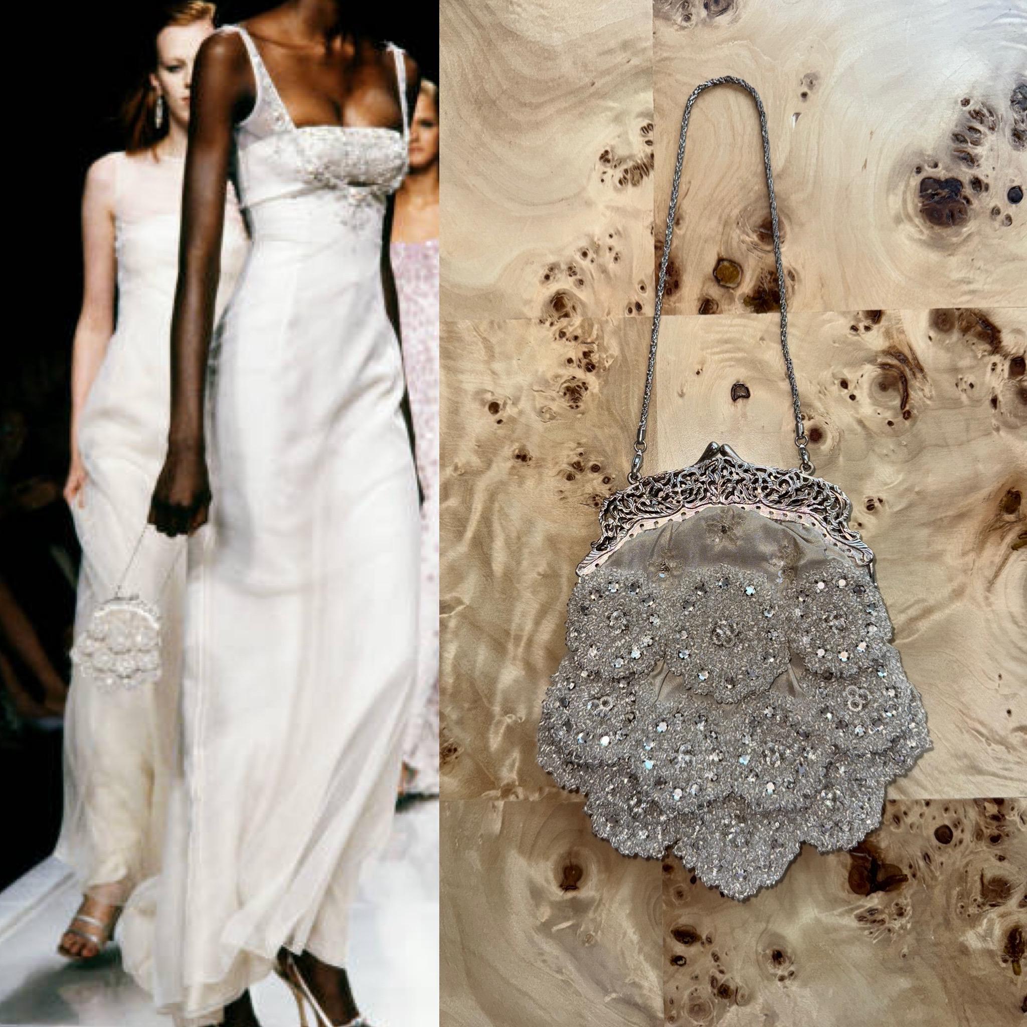Badgley Mischka
SS00
Runway
Vintage
Grey heavily beaded scalloped micro bag
Also has sequins and crystals
Silver ornate hardware with unique chain
Excellent vintage condition, no flaws
Measurements in inches laying flat: length 5, height excluding