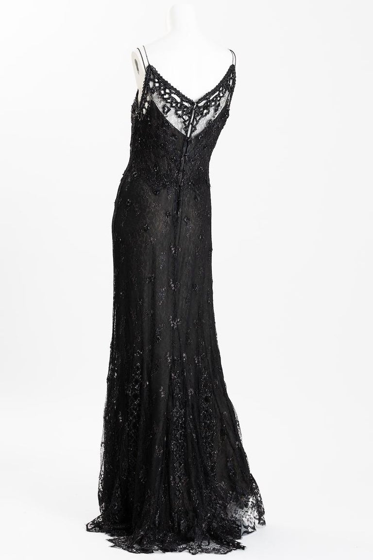 Badgley Mischka glamorous black silk lace evening gown, size US 10. 
Gown features hand beaded and embroidered lace with glass jet beading, and neckline with glass jet beads along cut out lacework. Back of gown features 8 faceted jet glass buttons