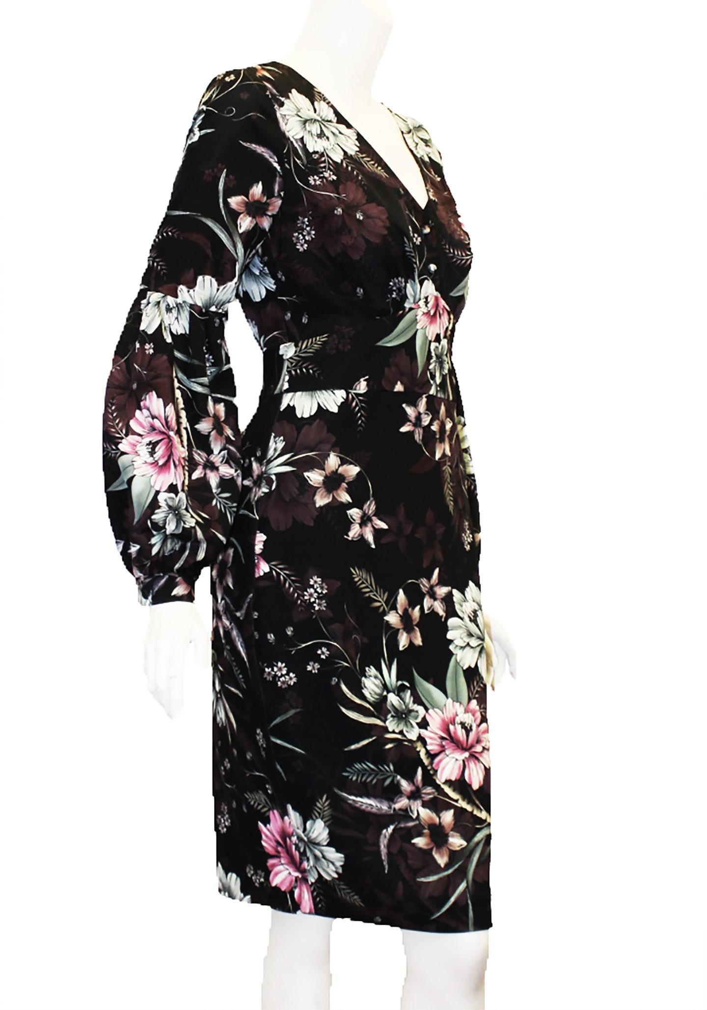 Badgley Mischka black base floral print dress with flowers in pink, burgundy, green and peach producing a blooming bouquet allover the dress.  Enhanced by a v neck and 2 covered buttons cinched at the waist this dress is casual but can easily be