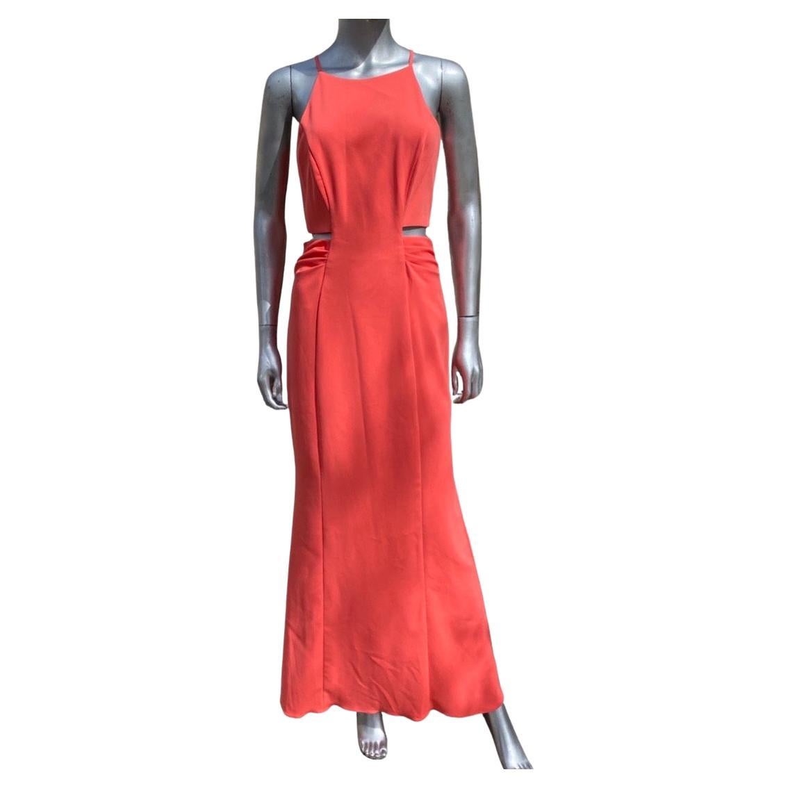A sexy slither of a dress designed by the team of Badgley Mischka for the collection label. (higher end). Cut-out sides above waist show a hint of skin. Flattering draped sides on waistline. Beautiful coral orange color. Fabric is a imported poly