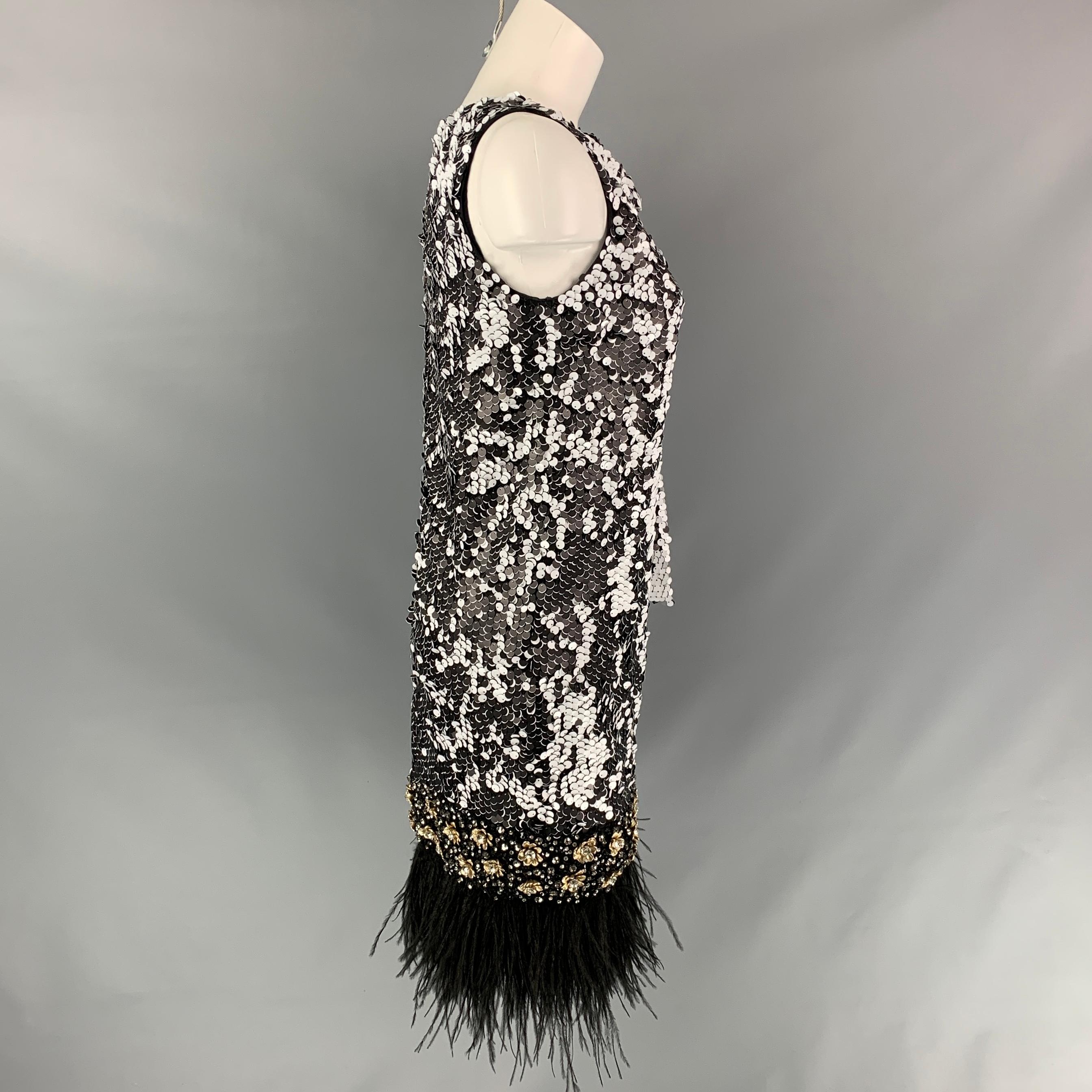 BADGLEY MISCHKA dress comes in a black & white sequined material featuring a shift style, shoulder bow detail, crystal embellishments, feather fringe trim, and a back zipper closure. 

Ver Good Pre-Owned Condition.
Marked: Size tag