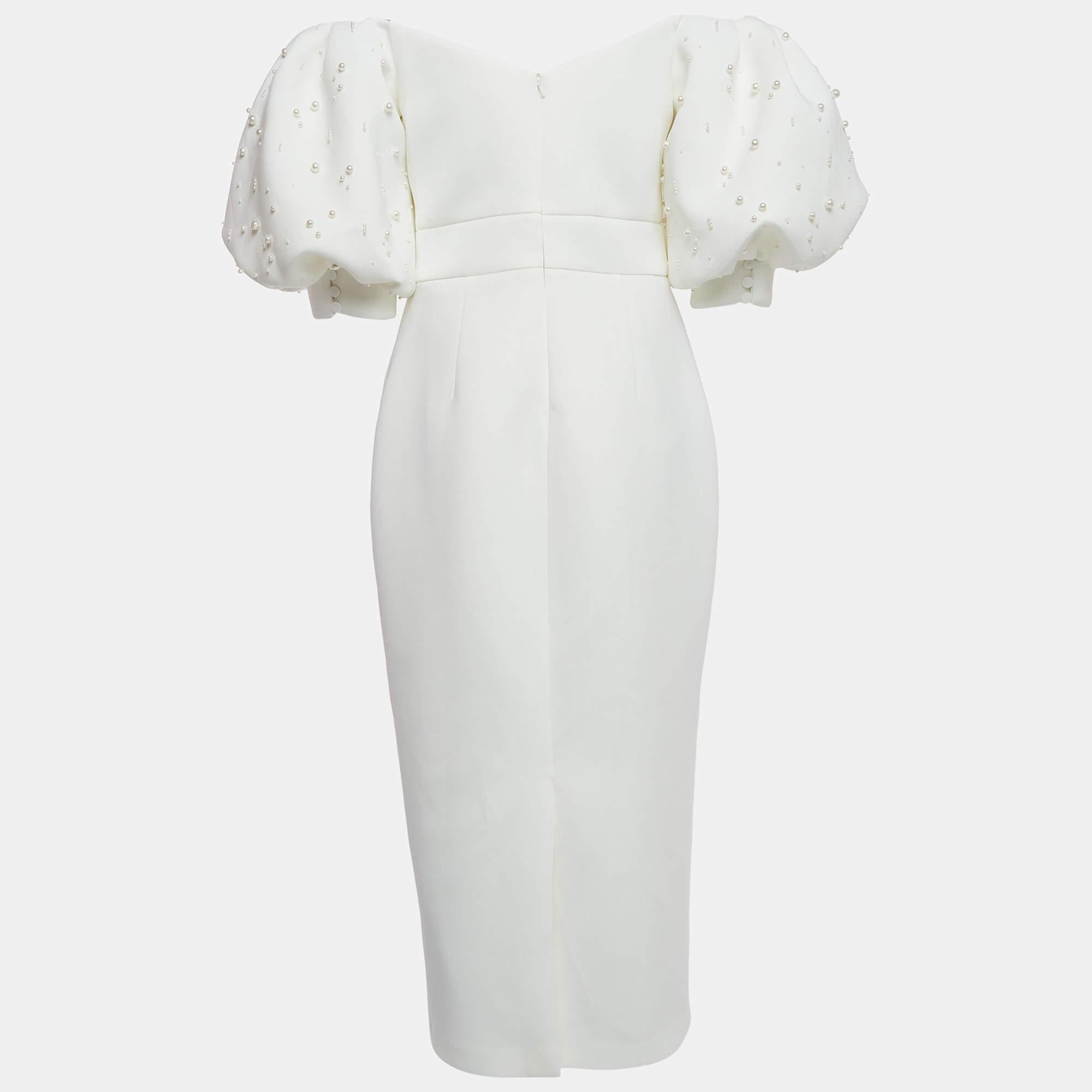 This stylish ivory dress with pearl embellishment exudes elegance and sophistication. Its flattering midi length offers a versatile option for various occasions. Delicate and exquisitely feminine, the dress is perfect for evenings, dates, and even a